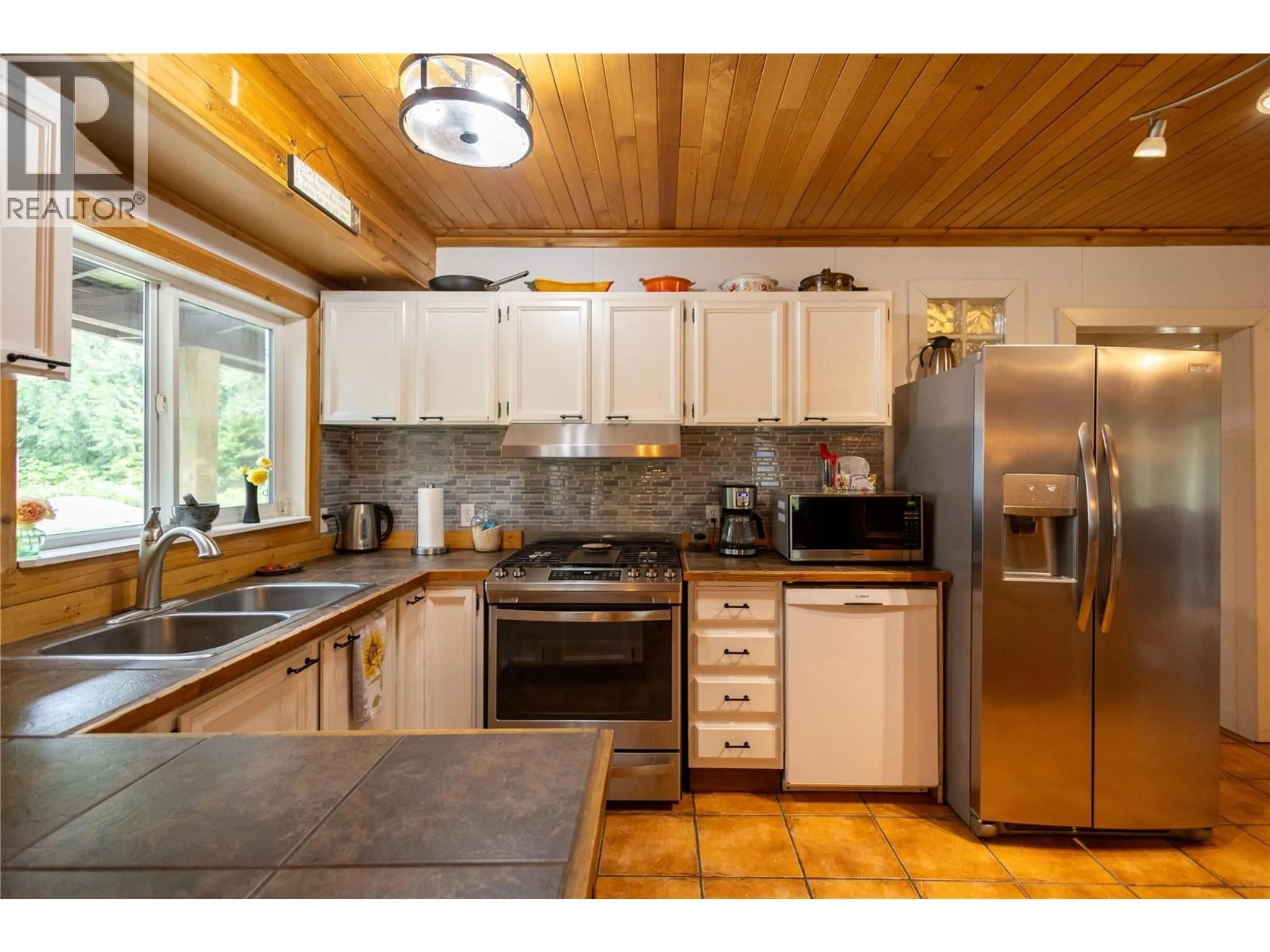 Open concept kitchen, wood/laminate floor for 4453 PASSMORE UPPER ROAD, Passmore British Columbia V0G2J0