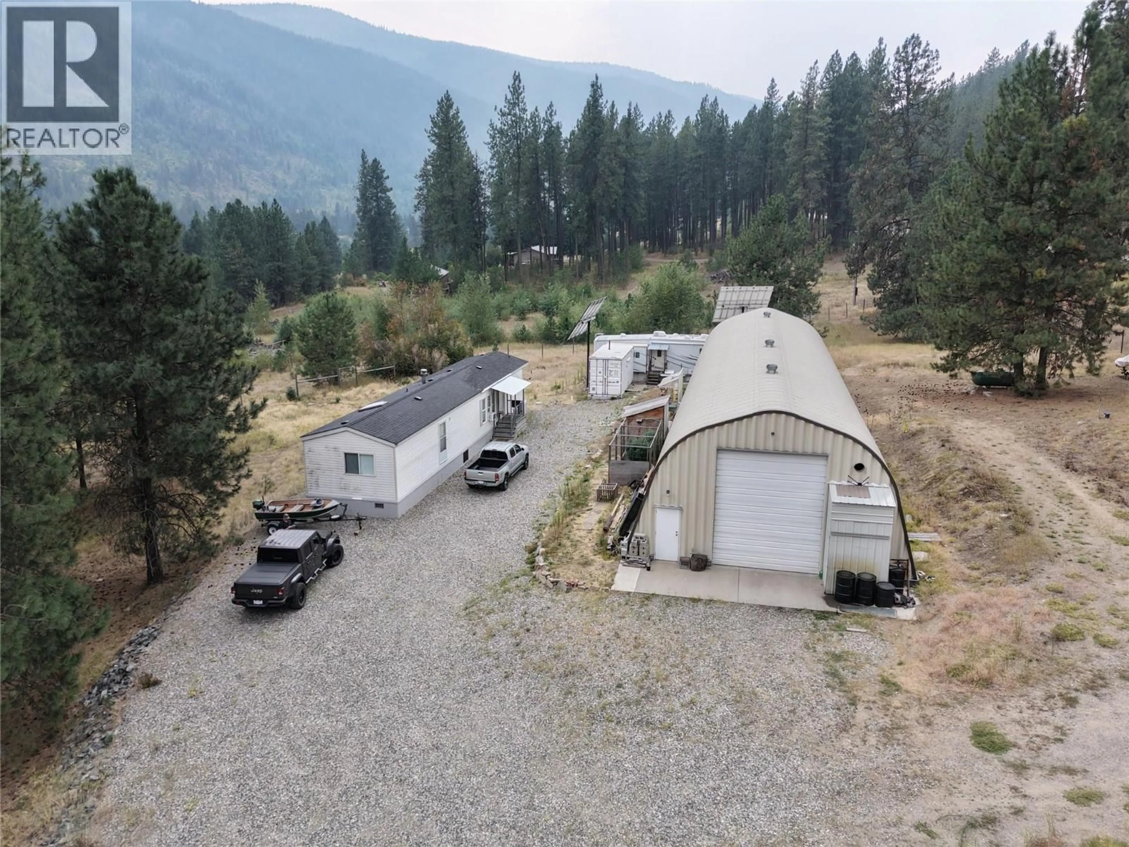 A pic from outside/outdoor area/front of a property/back of a property/a pic from drone, mountain view for 765 3 HIGHWAY, Grand Forks British Columbia V0H1H0