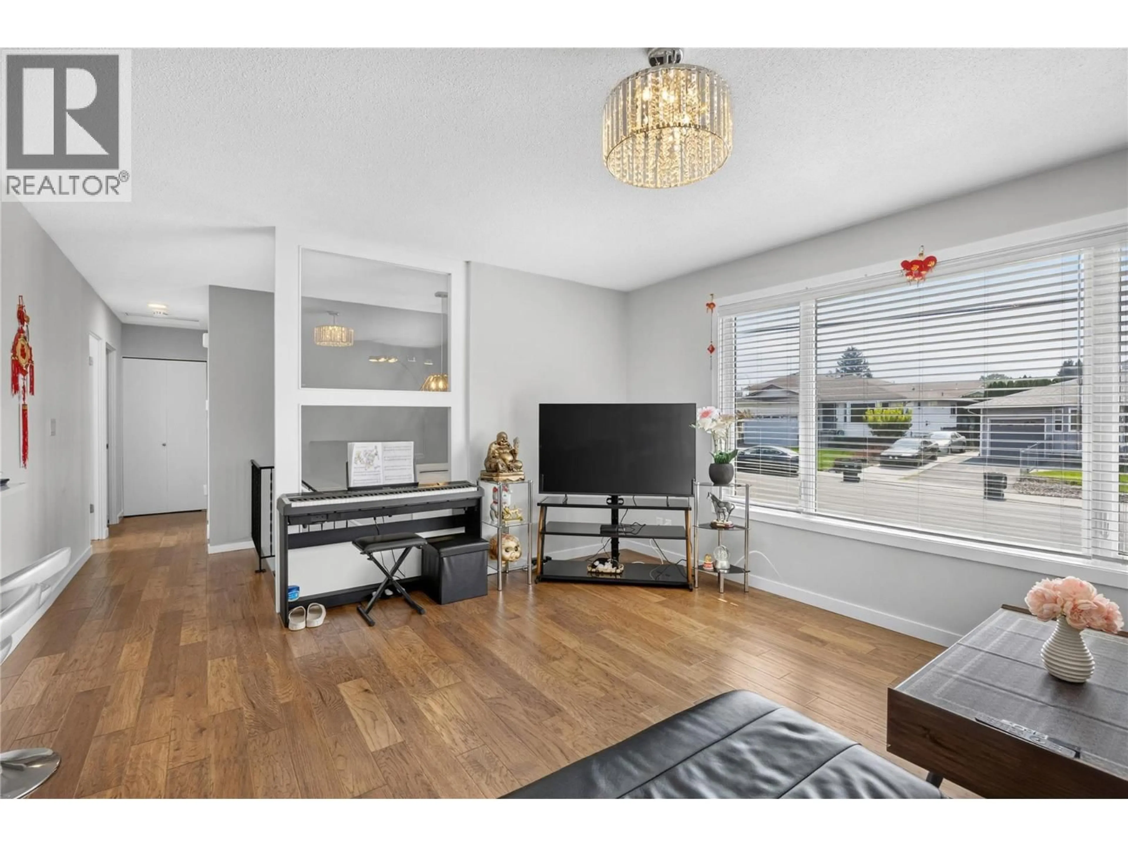 Living room with furniture, wood/laminate floor for 127 OKANAGAN AVENUE WEST, Penticton British Columbia V2A3L2