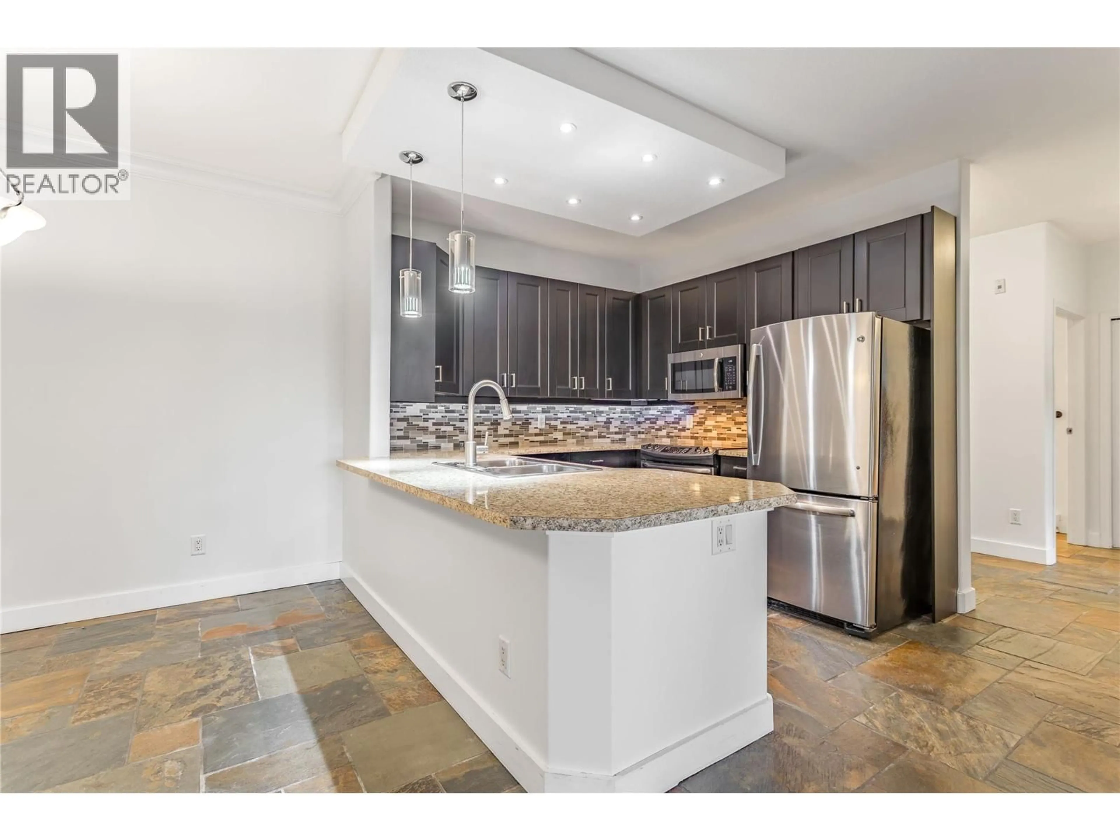 Open concept kitchen, ceramic/tile floor for 103 - 2300 BENVOULIN ROAD, Kelowna British Columbia V1W2C6