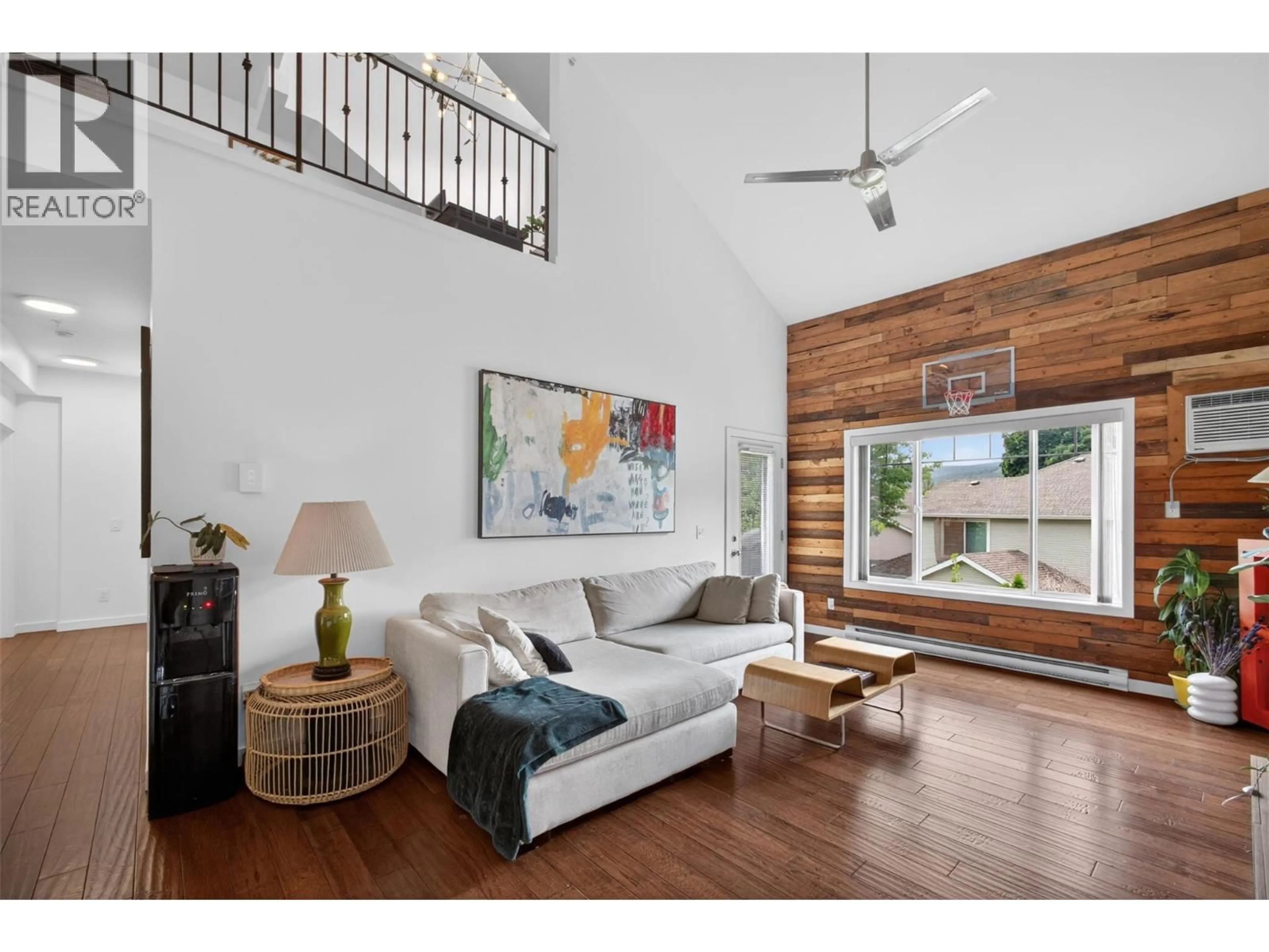 Living room with furniture, wood/laminate floor for 303 - 2120 SHANNON RIDGE DRIVE, West Kelowna British Columbia V4T2Z3