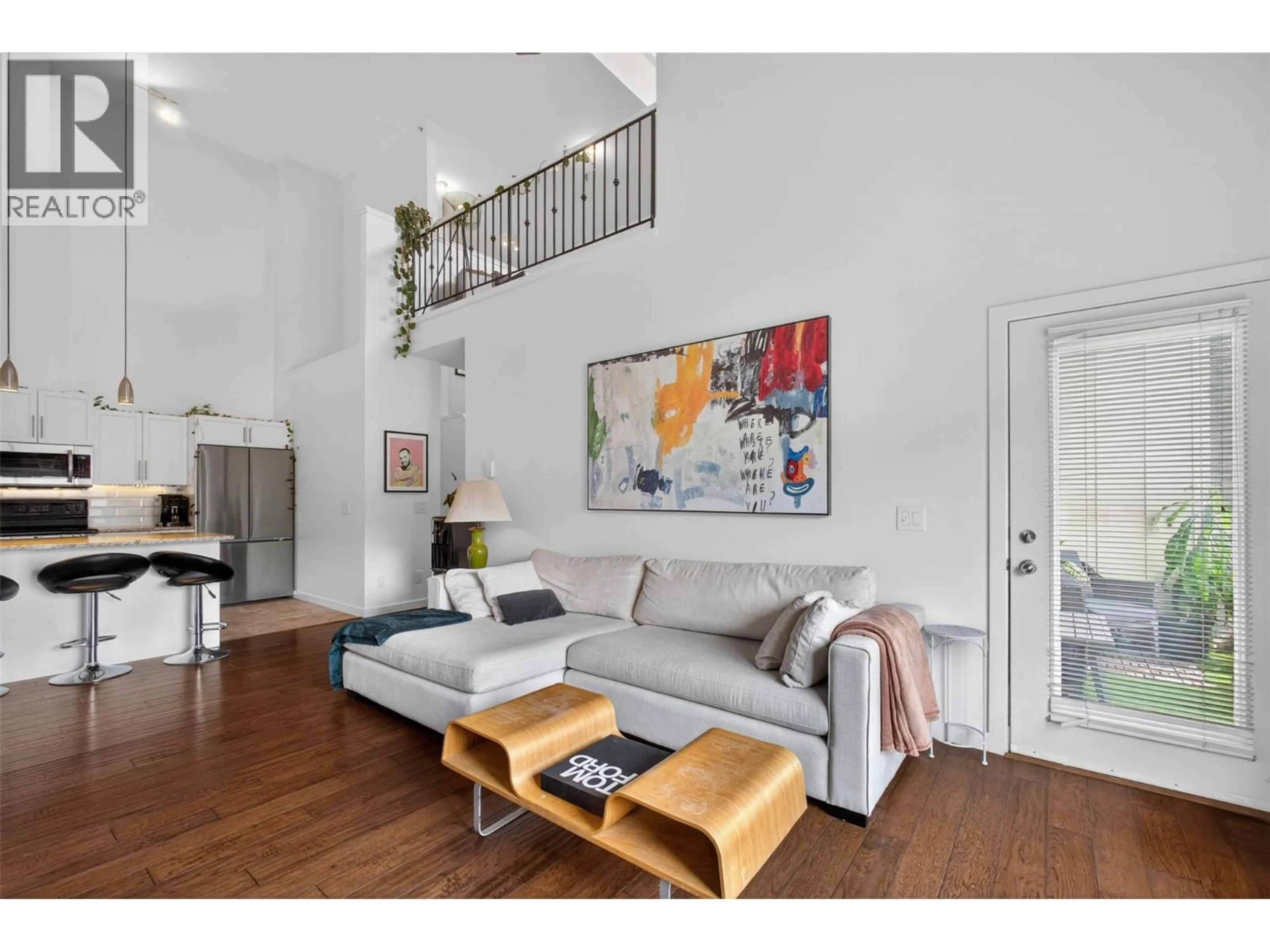 Living room with furniture, wood/laminate floor for 303 - 2120 SHANNON RIDGE DRIVE, West Kelowna British Columbia V4T2Z3