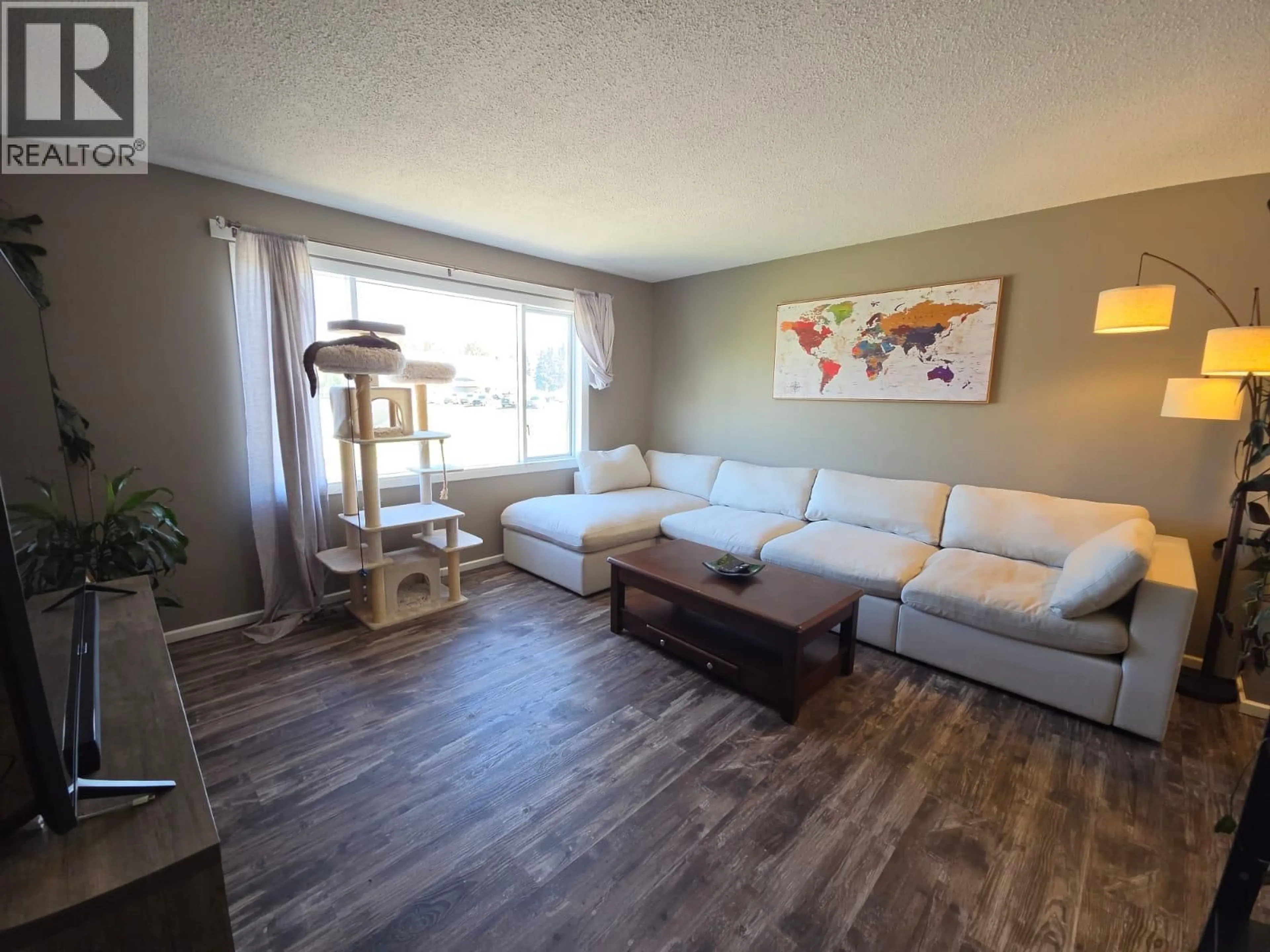 Living room with furniture, wood/laminate floor for 4317 51A AVENUE NORTHEAST, Chetwynd British Columbia V0C1J0