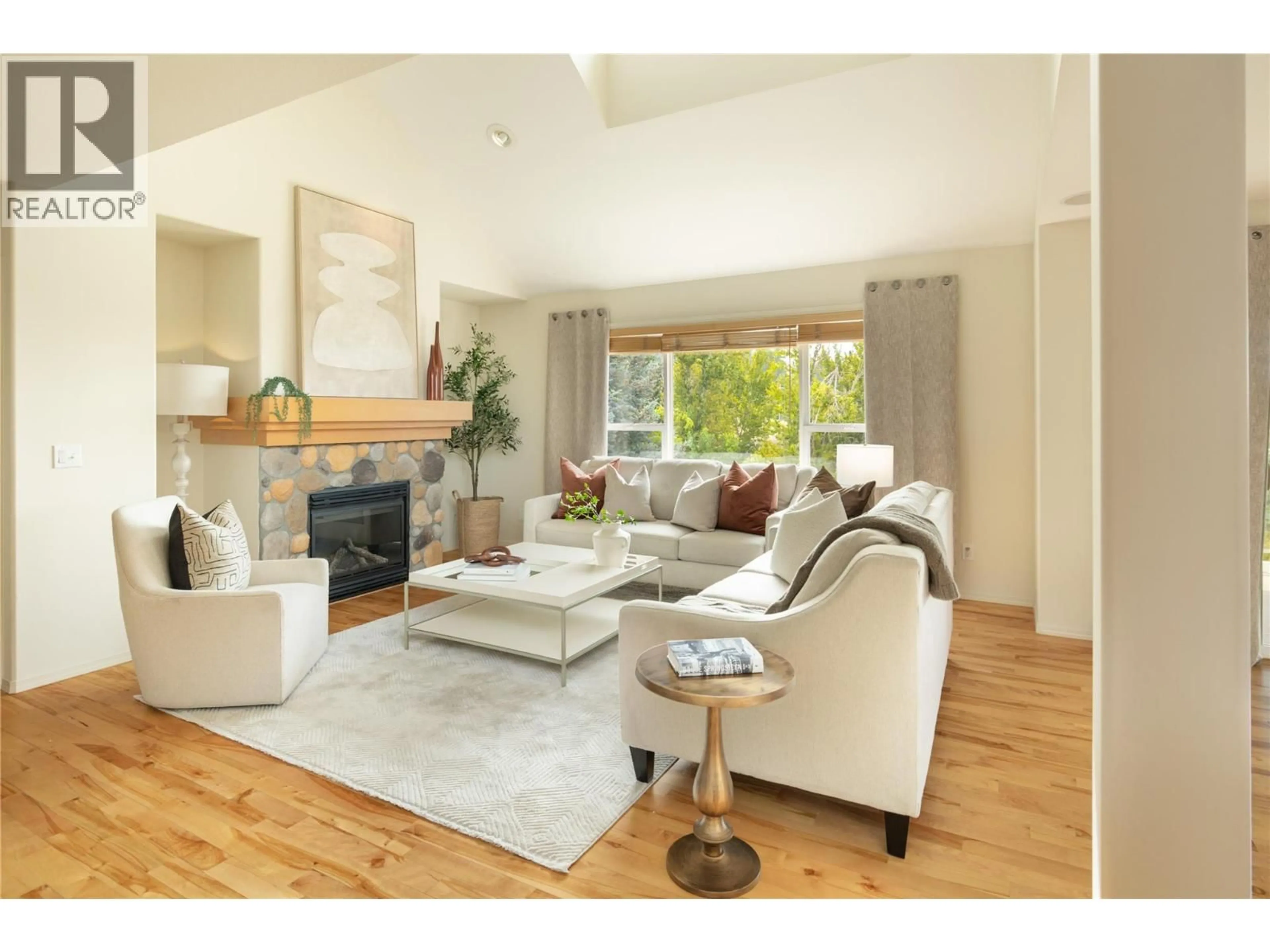 Living room with furniture, wood/laminate floor for 5281 SILVERADO PLACE, Kelowna British Columbia V1X7X8