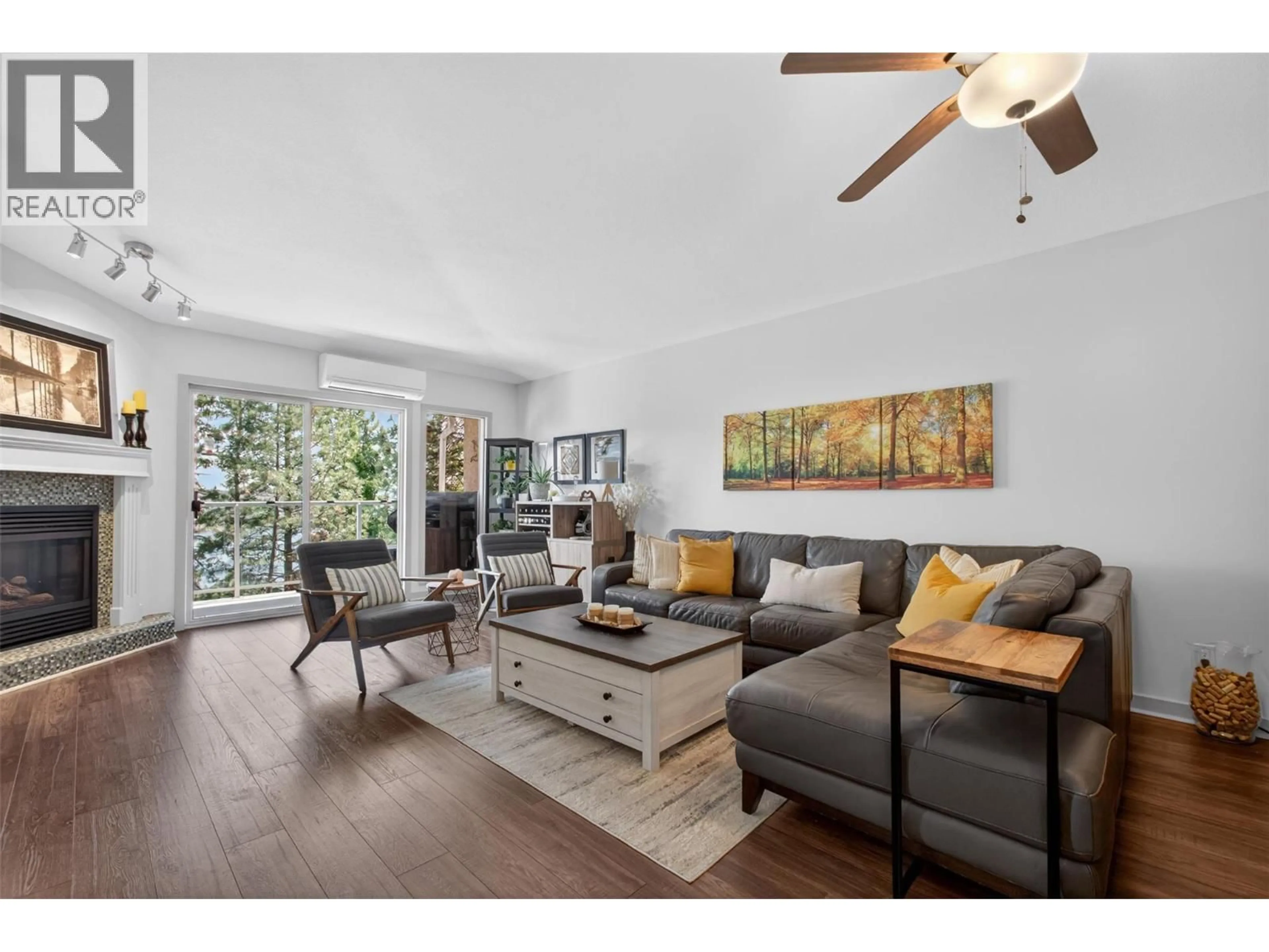 Living room with furniture, wood/laminate floor for 308 - 4630 PONDEROSA DRIVE, Peachland British Columbia V0X1H5