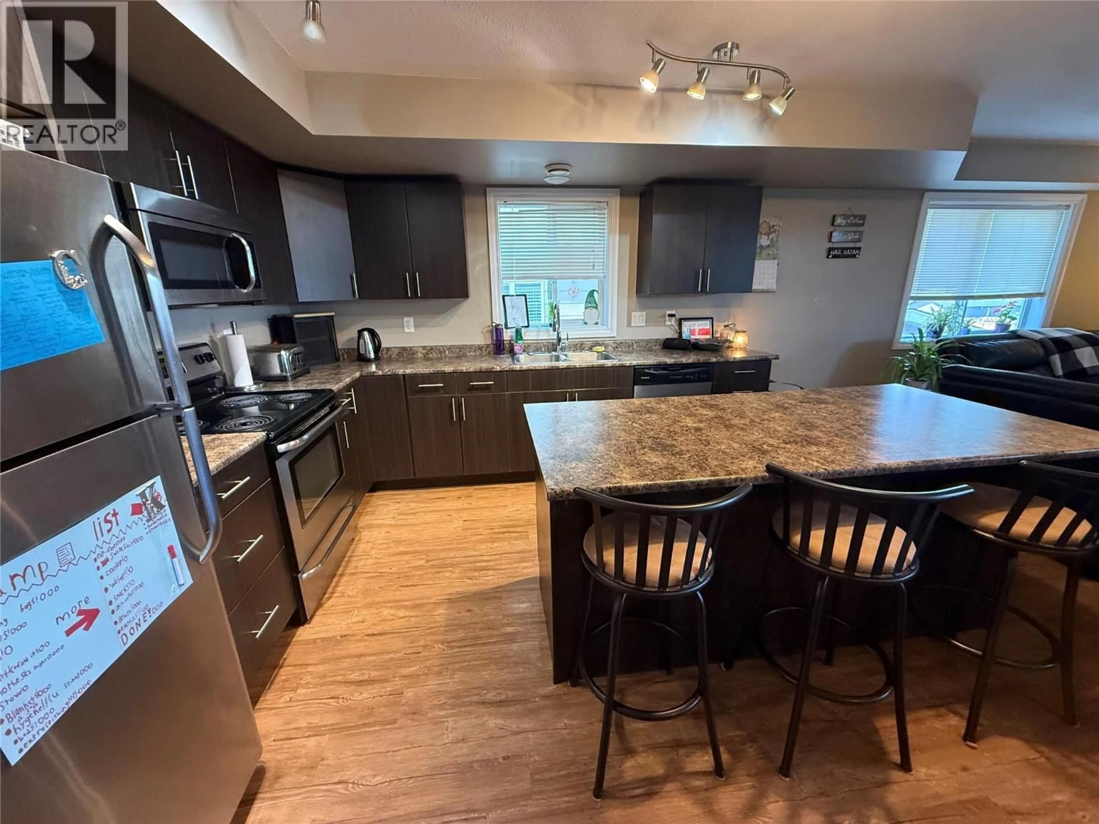 Open concept kitchen, wood/laminate floor for 8107 18 STREET, Dawson Creek British Columbia V1G0G4