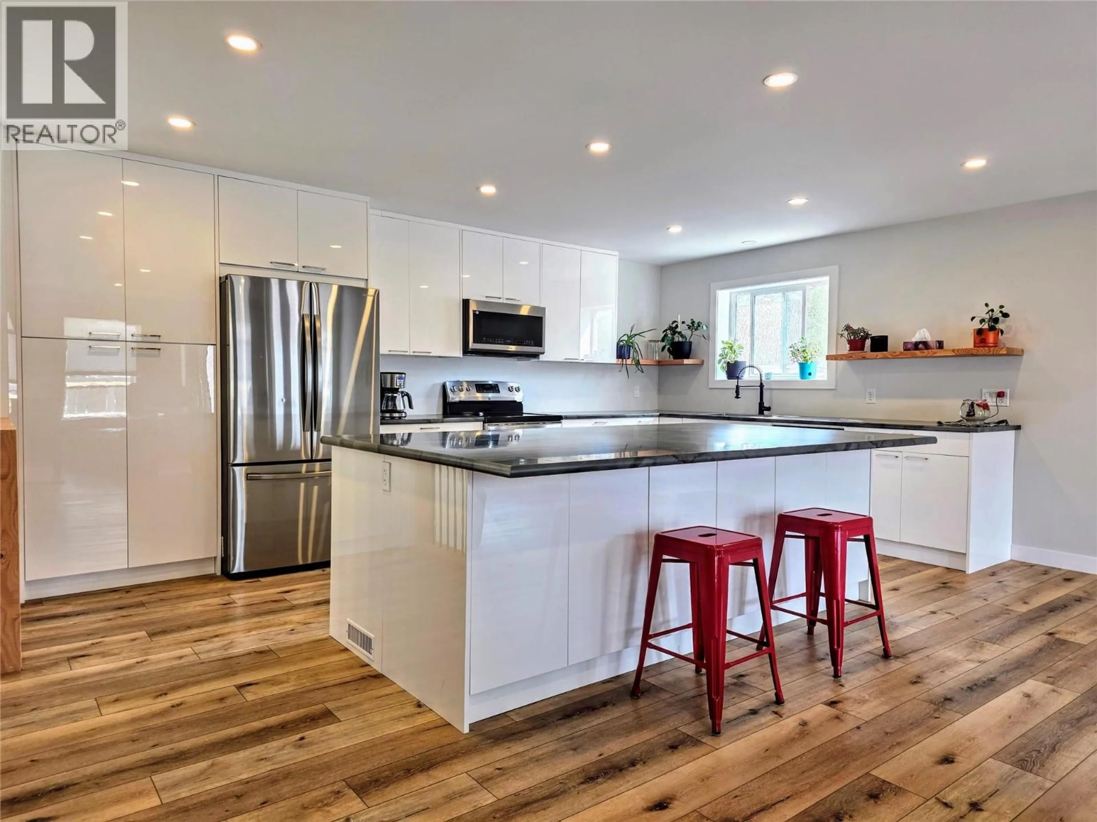 Open concept kitchen, wood/laminate floor for 1313 13TH AVENUE, Invermere British Columbia V0A1K4