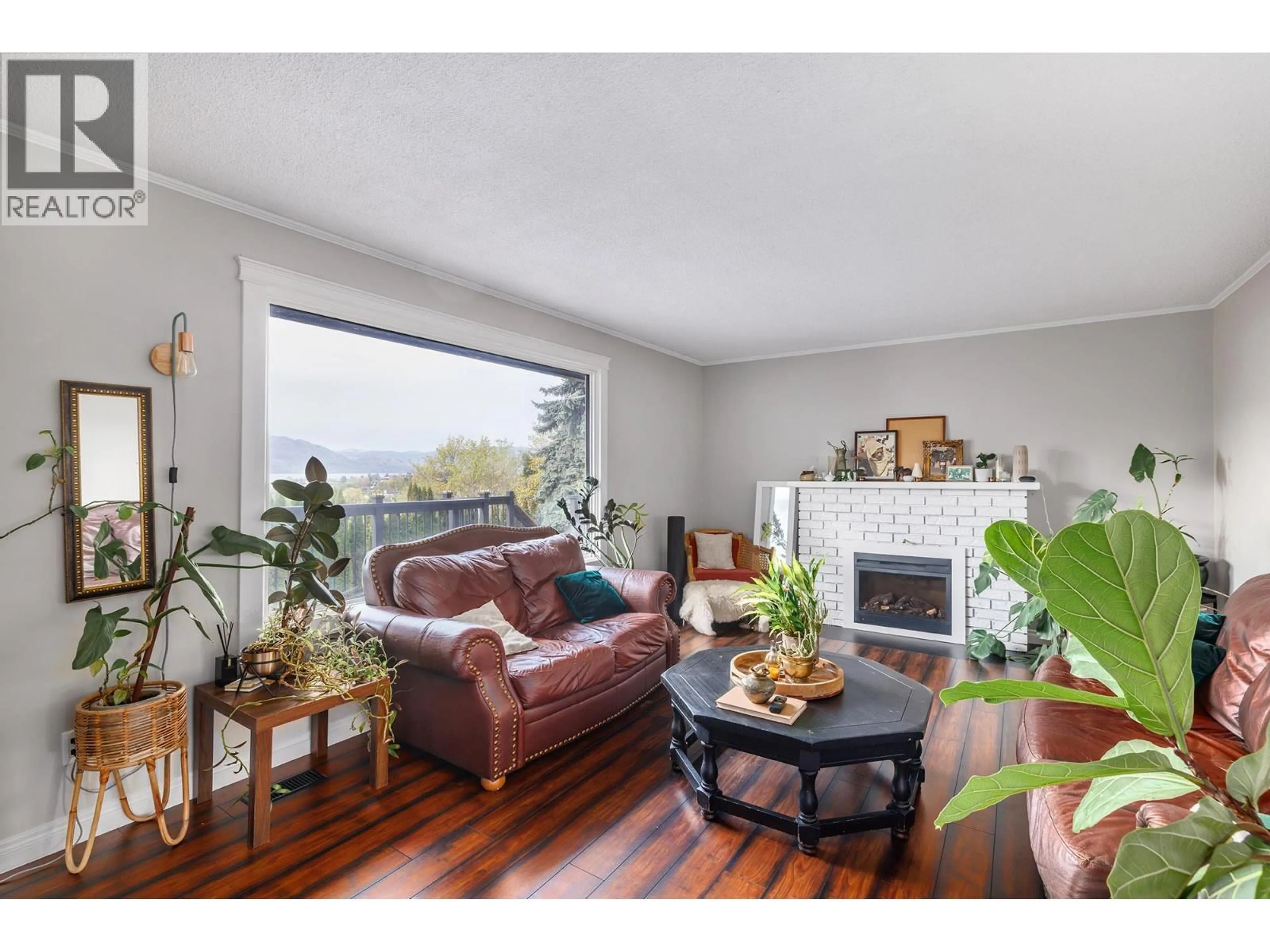 Living room with furniture, wood/laminate floor for 1185 SUNNYSIDE ROAD, West Kelowna British Columbia V1Z2S5
