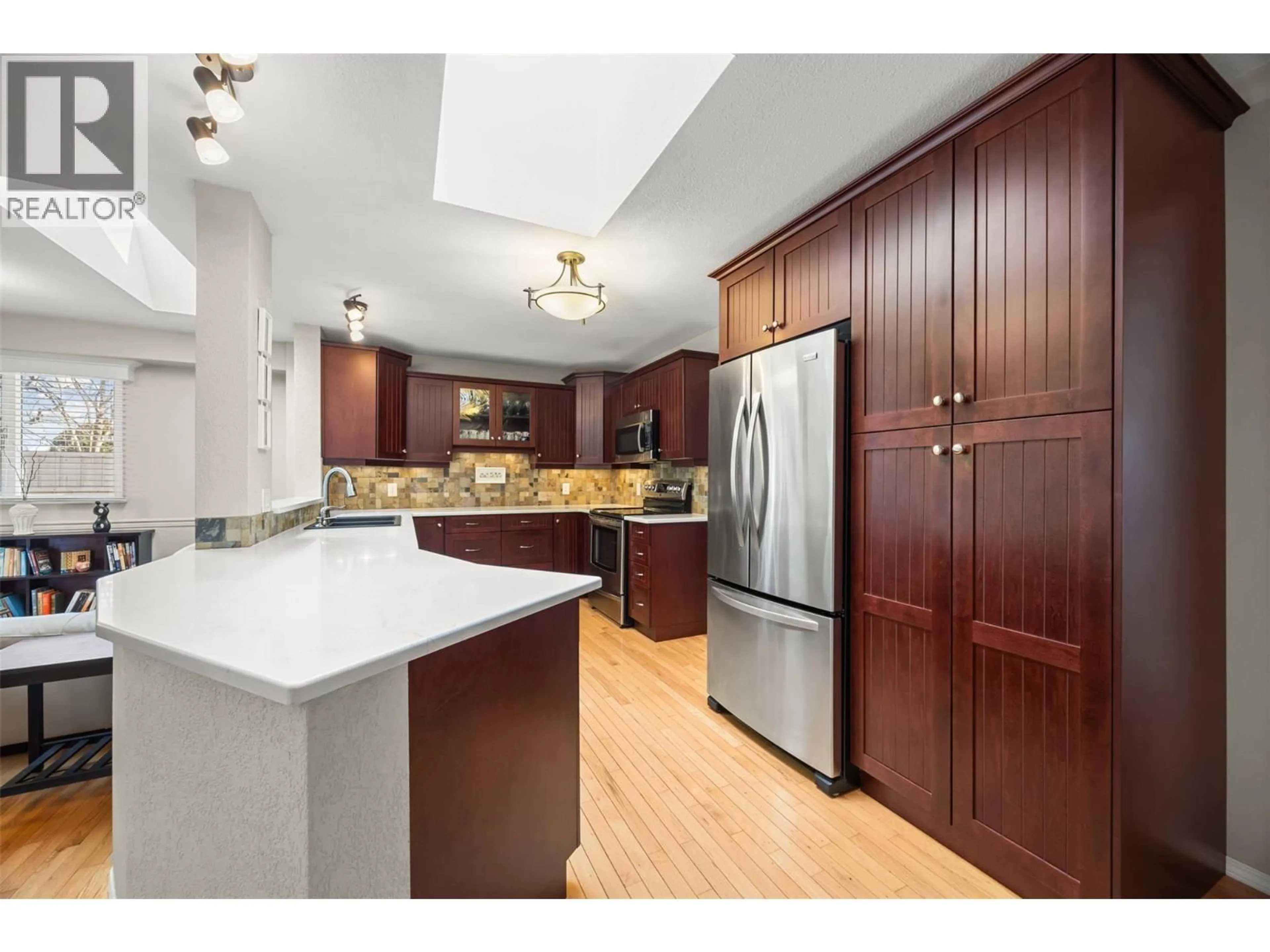 Open concept kitchen, wood/laminate floor for 1384 NELSON PLACE, Kelowna British Columbia V1Y9H4