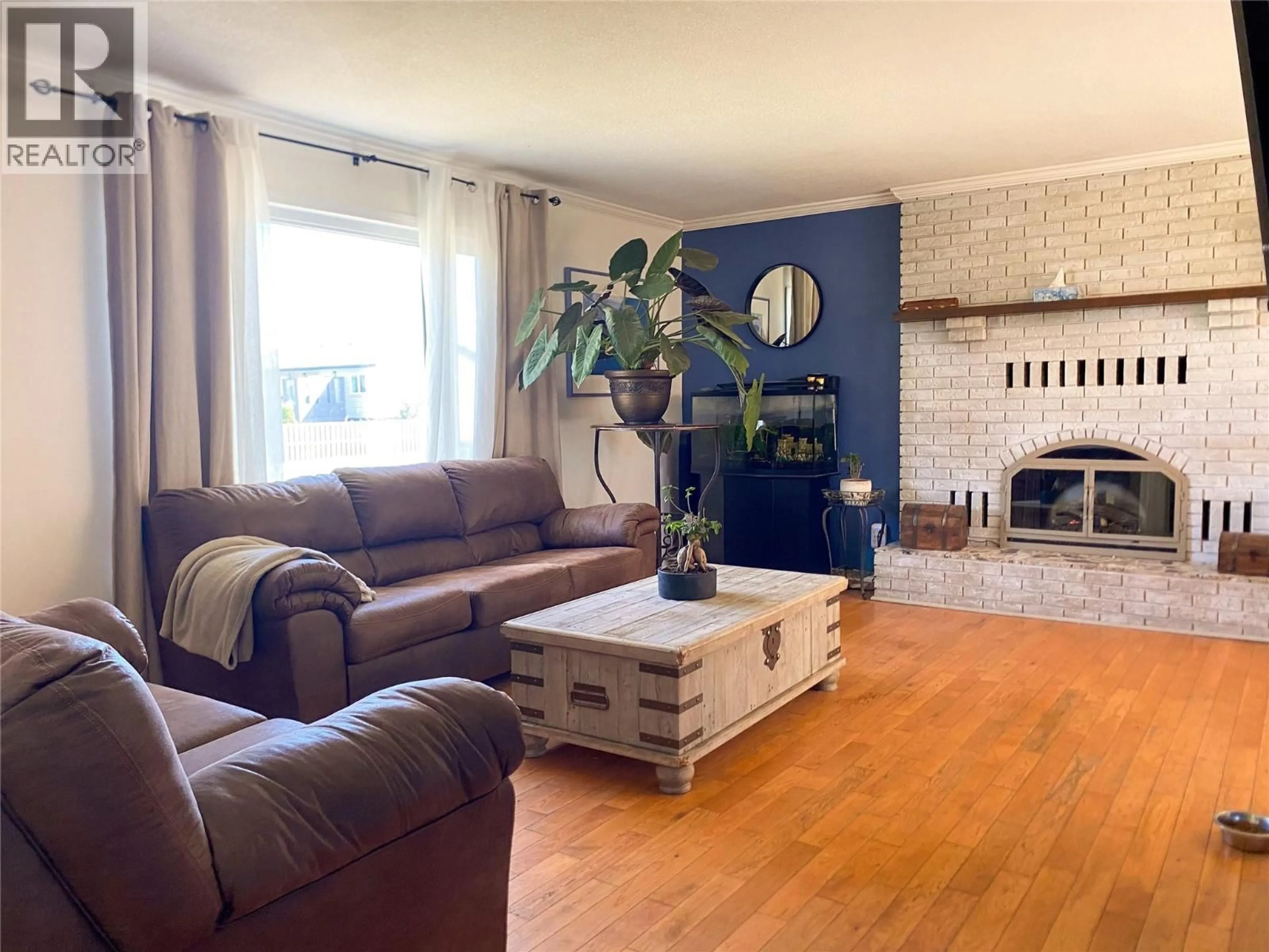 Living room with furniture, wood/laminate floor for 9017 17 STREET, Dawson Creek British Columbia V1G4A5