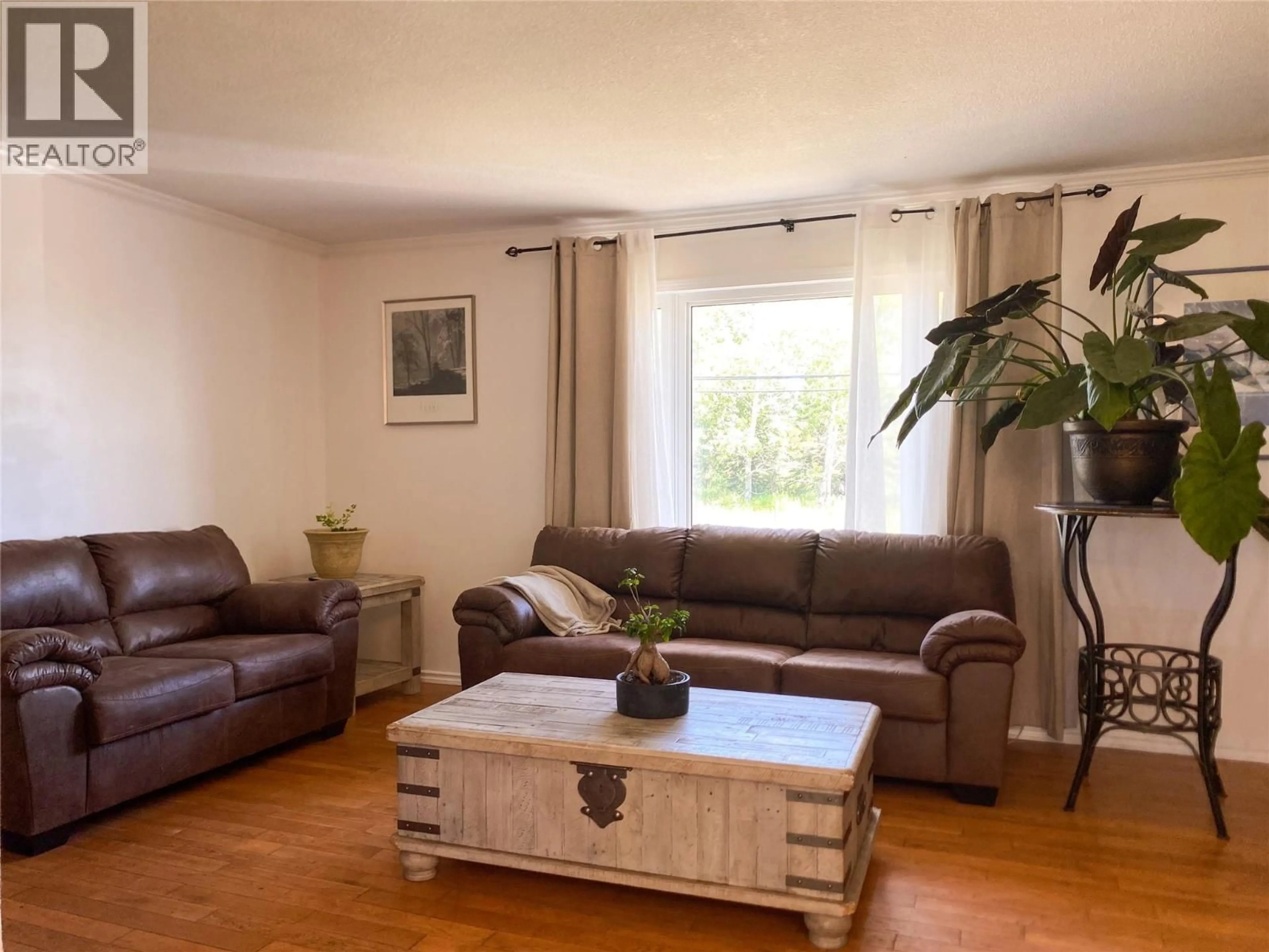Living room with furniture, wood/laminate floor for 9017 17 STREET, Dawson Creek British Columbia V1G4A5