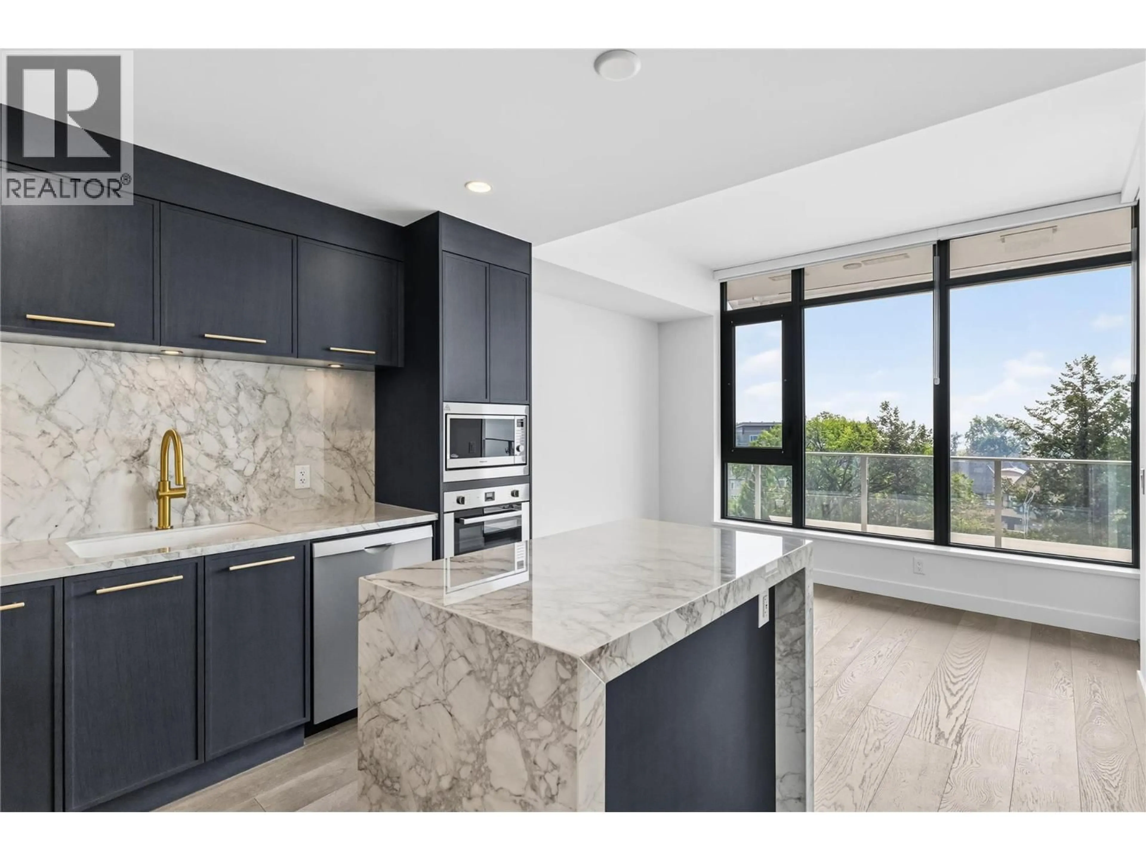 Open concept kitchen, ceramic/tile floor for 701 - 3800 CAPOZZI ROAD, Kelowna British Columbia V1W0J6