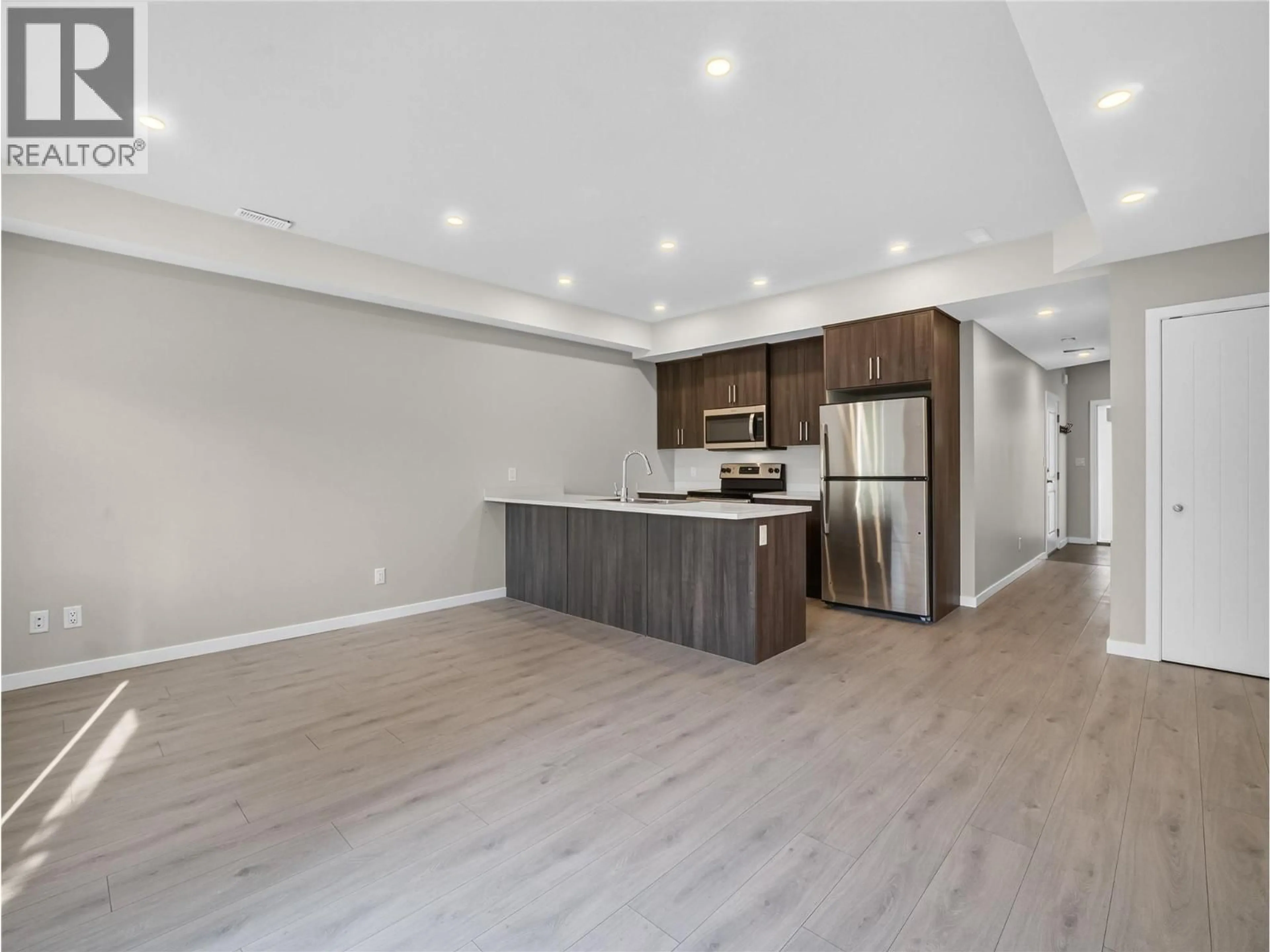 Open concept kitchen, wood/laminate floor for 13 - 2081 11 AVENUE NORTHEAST, Salmon Arm British Columbia V1E0G1