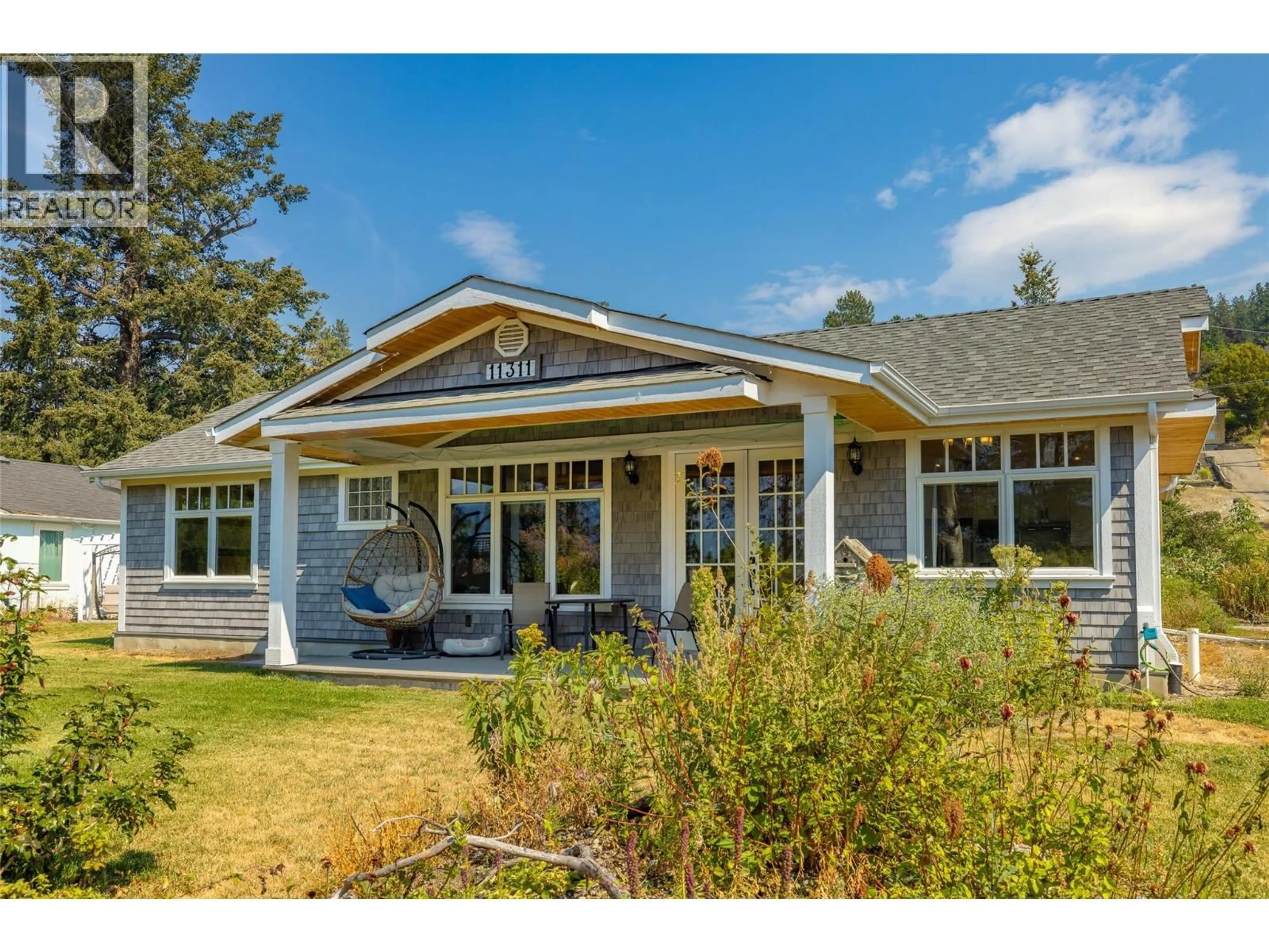 Home with vinyl exterior material, street for 11311 OKANAGAN CENTRE ROAD WEST, Lake Country British Columbia V4V2J6