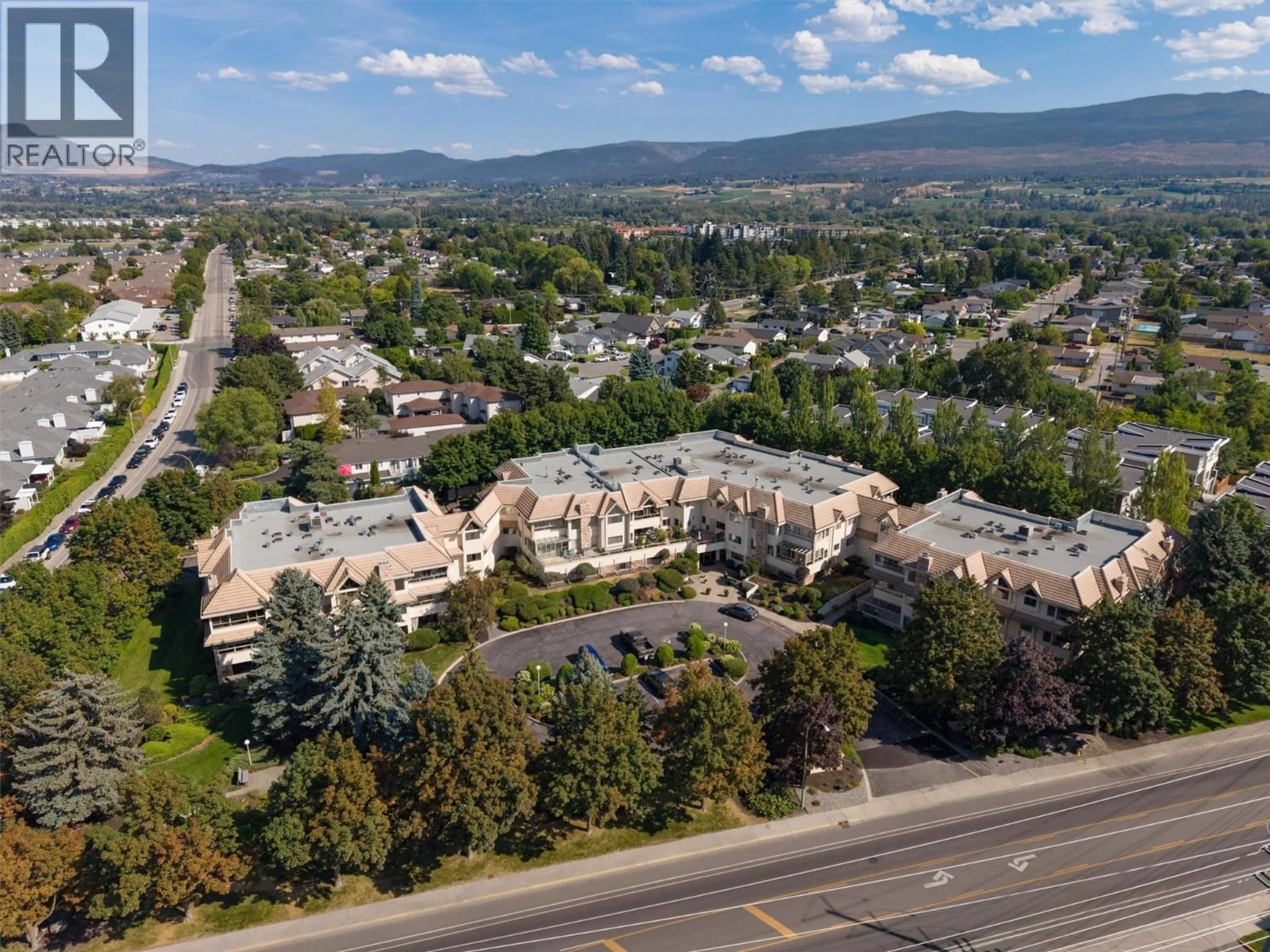 A pic from outside/outdoor area/front of a property/back of a property/a pic from drone, mountain view for 101 - 3335 RICHTER STREET, Kelowna British Columbia V1W3Y1