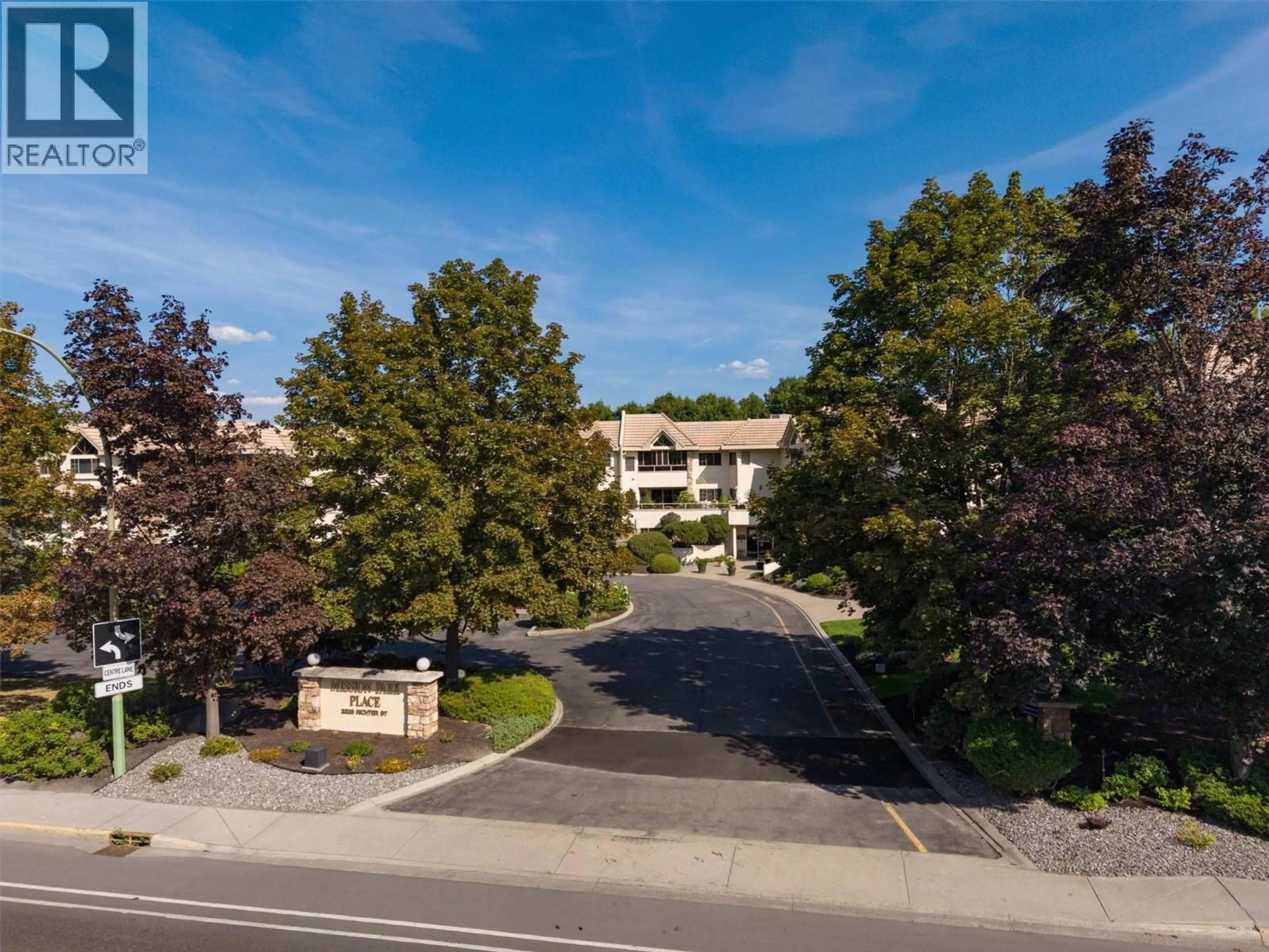 A pic from outside/outdoor area/front of a property/back of a property/a pic from drone, mountain view for 101 - 3335 RICHTER STREET, Kelowna British Columbia V1W3Y1