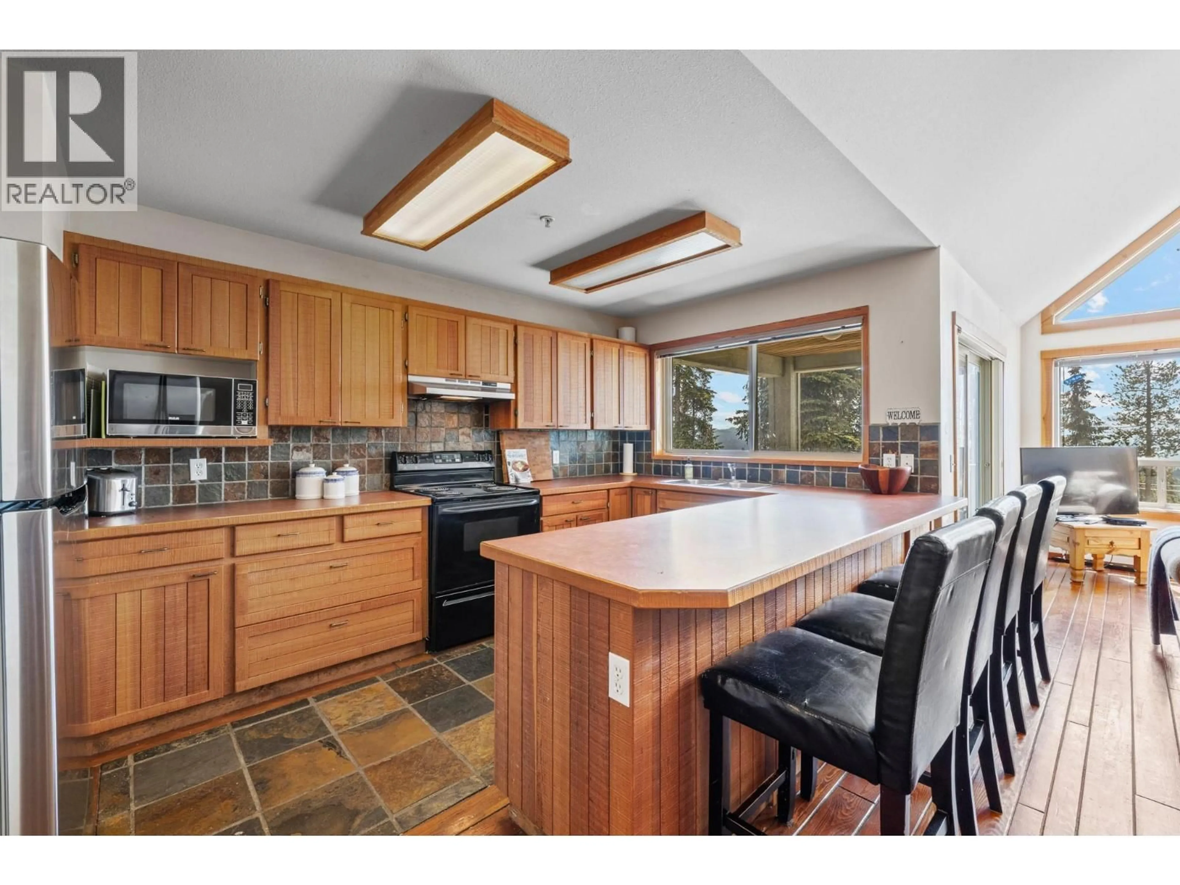 Open concept kitchen, ceramic/tile floor for 4879A SNOWPINES ROAD, Big White British Columbia V1P1P3