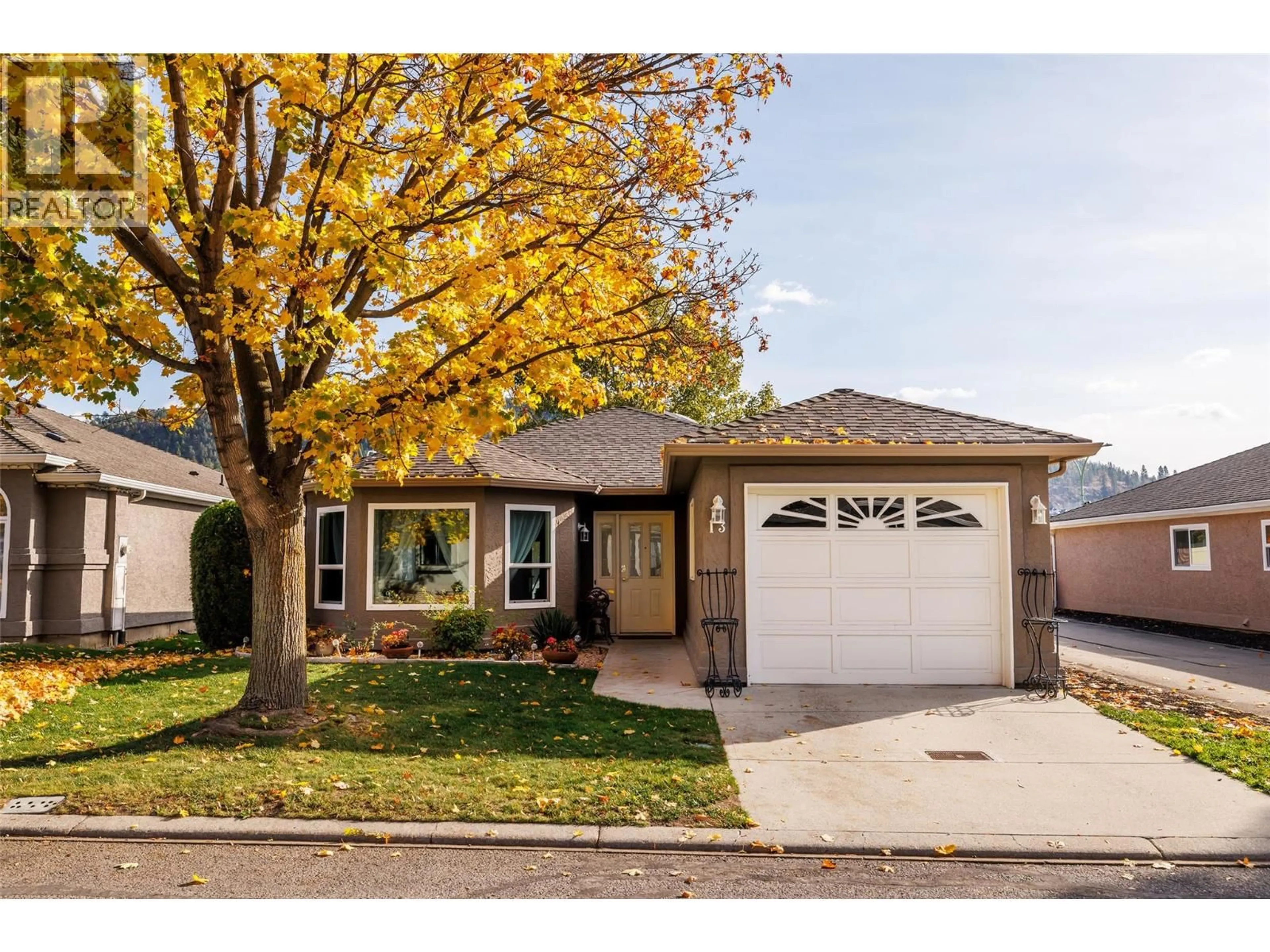 Home with vinyl exterior material, street for 13 - 615 GLENMEADOWS ROAD, Kelowna British Columbia V1V1N9