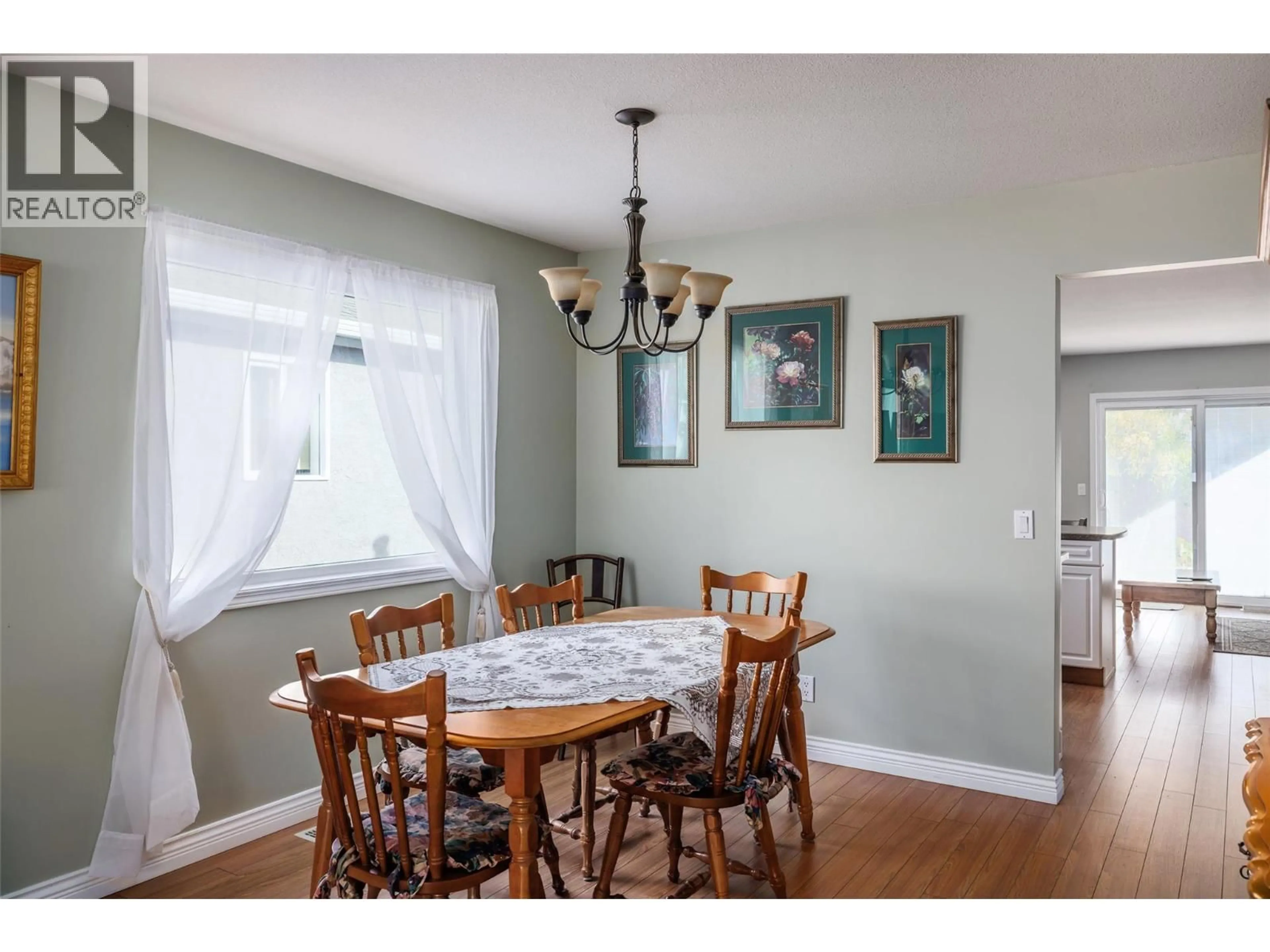 Dining room, wood/laminate floor for 13 - 615 GLENMEADOWS ROAD, Kelowna British Columbia V1V1N9