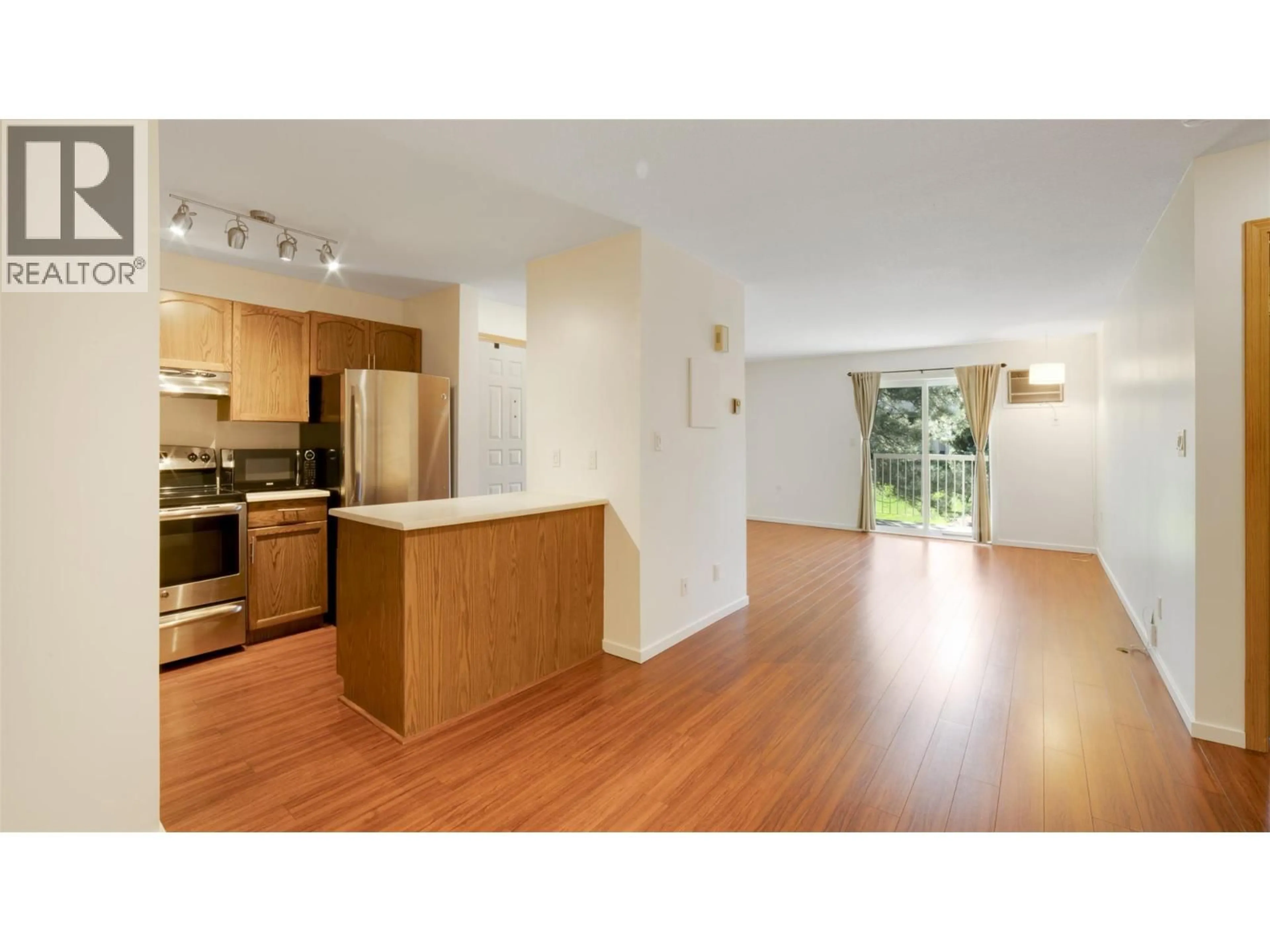 Open concept kitchen, wood/laminate floor for 208D - 735 COOK ROAD, Kelowna British Columbia V1W3G6