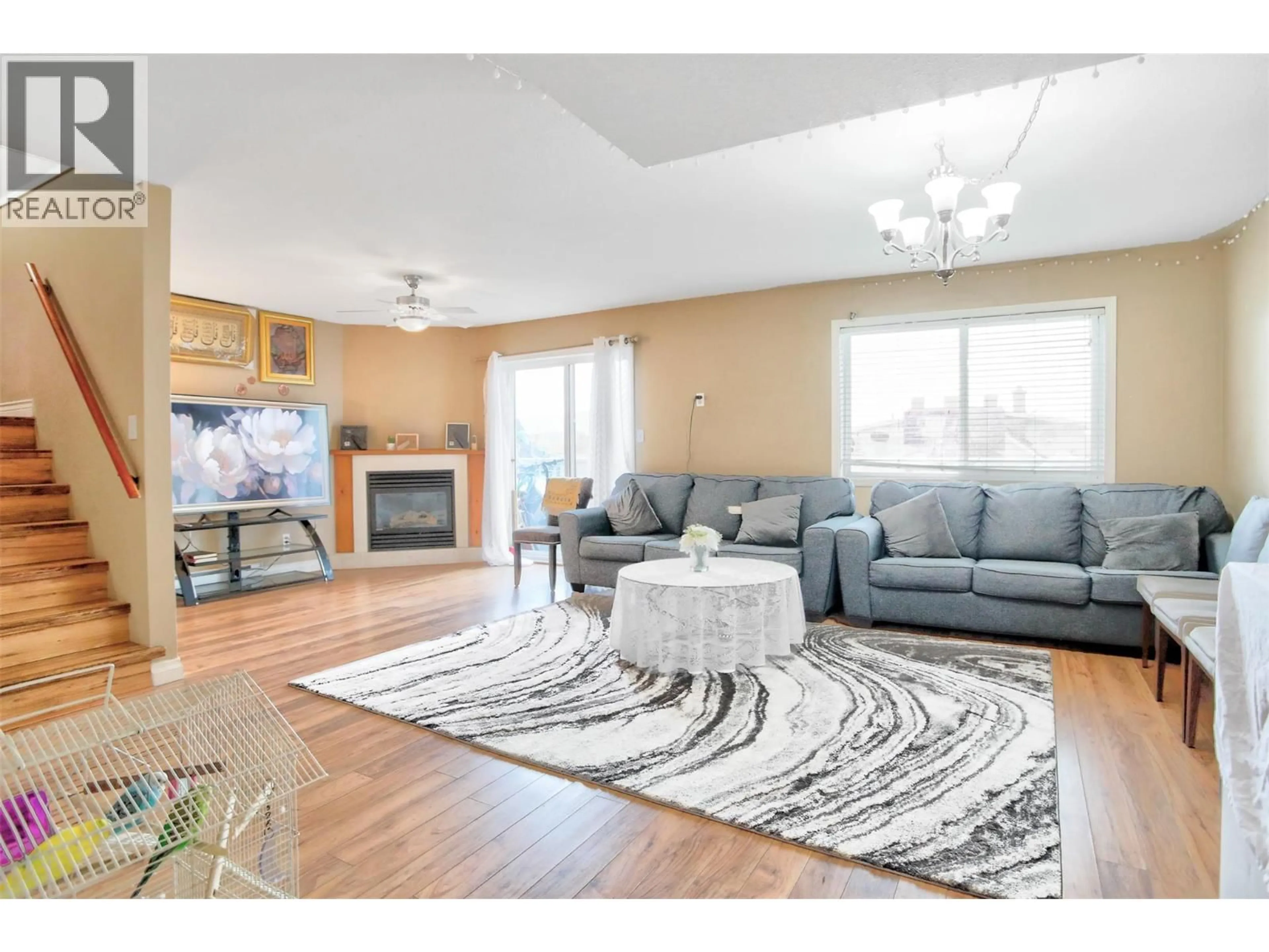 Living room with furniture, wood/laminate floor for 203 - 95 ECKHARDT AVENUE, Penticton British Columbia V2A8L2