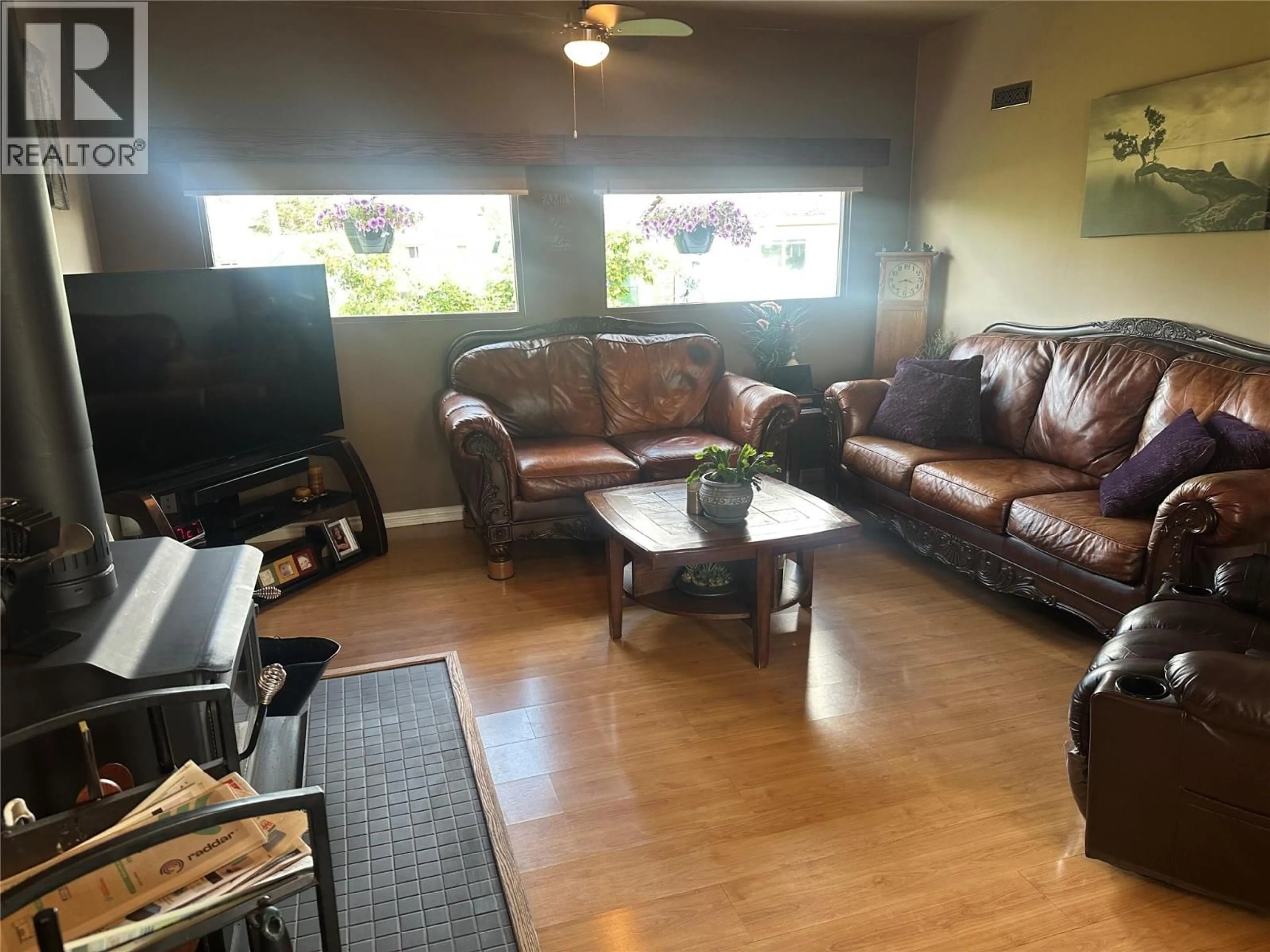Living room with furniture, wood/laminate floor for 11324 13A STREET, Dawson Creek British Columbia V1G3X7
