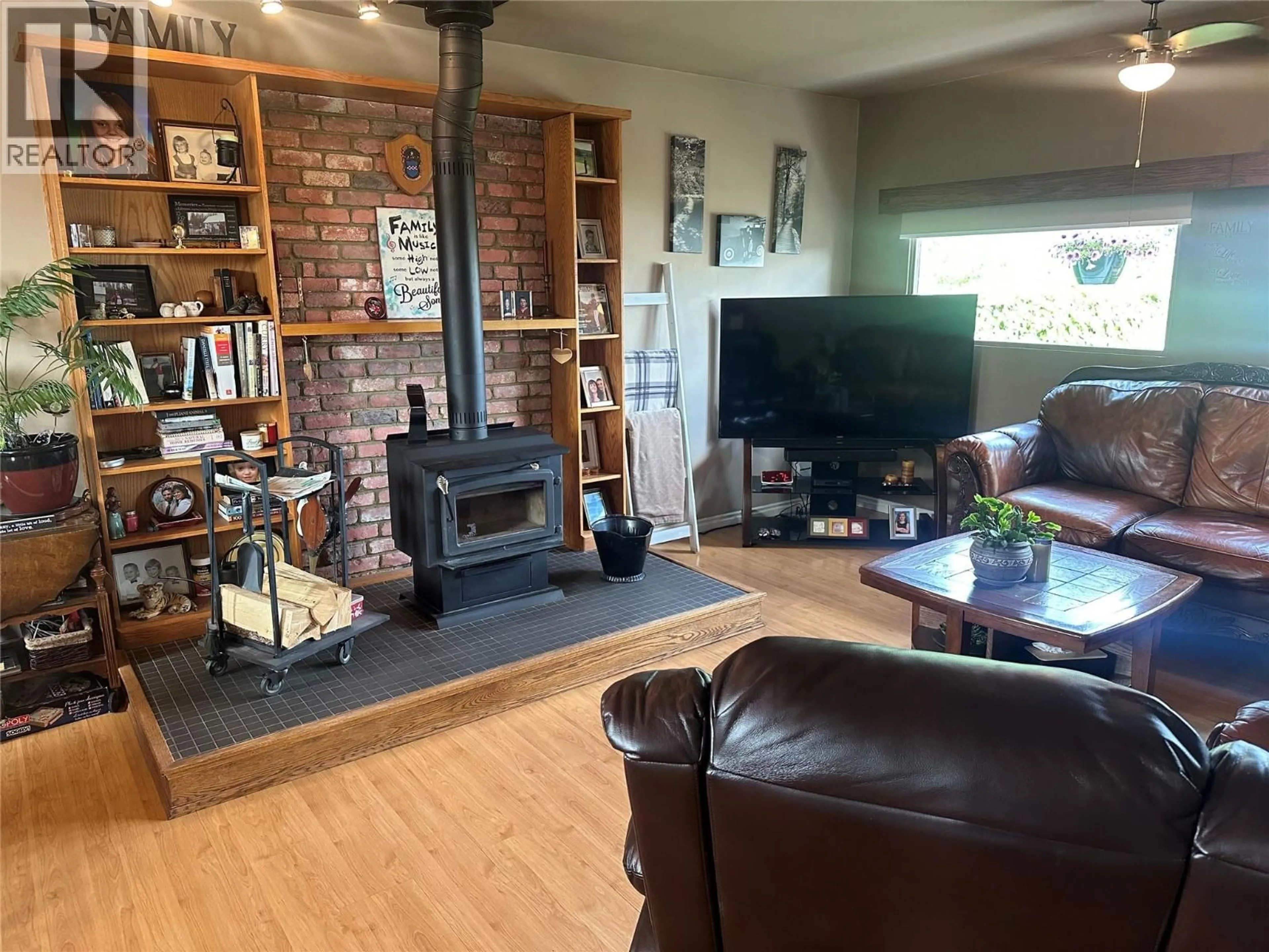 Living room with furniture, wood/laminate floor for 11324 13A STREET, Dawson Creek British Columbia V1G3X7