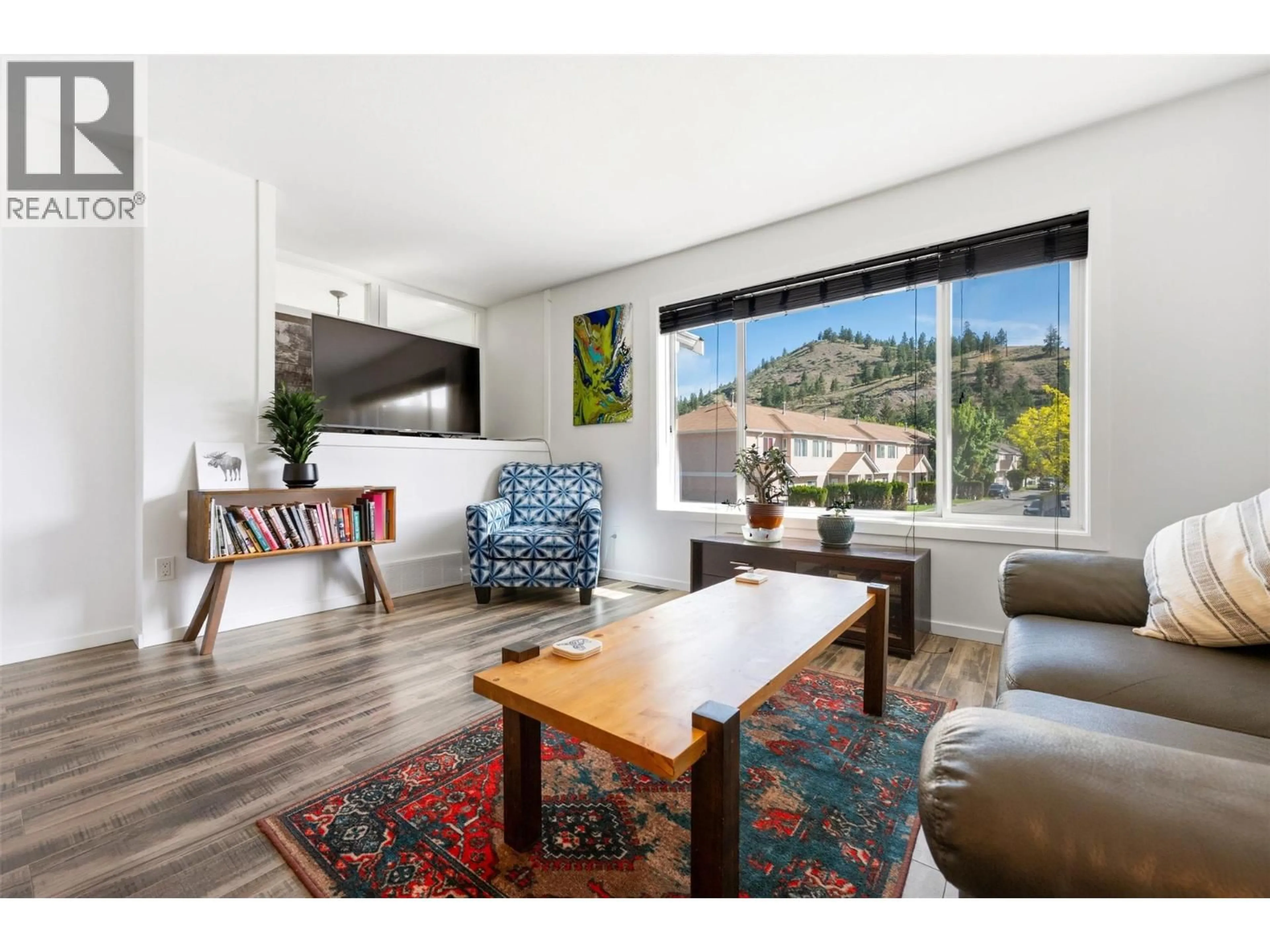 Living room with furniture, wood/laminate floor for 189 - 1458 PENTICTON AVENUE, Penticton British Columbia V2A8L3