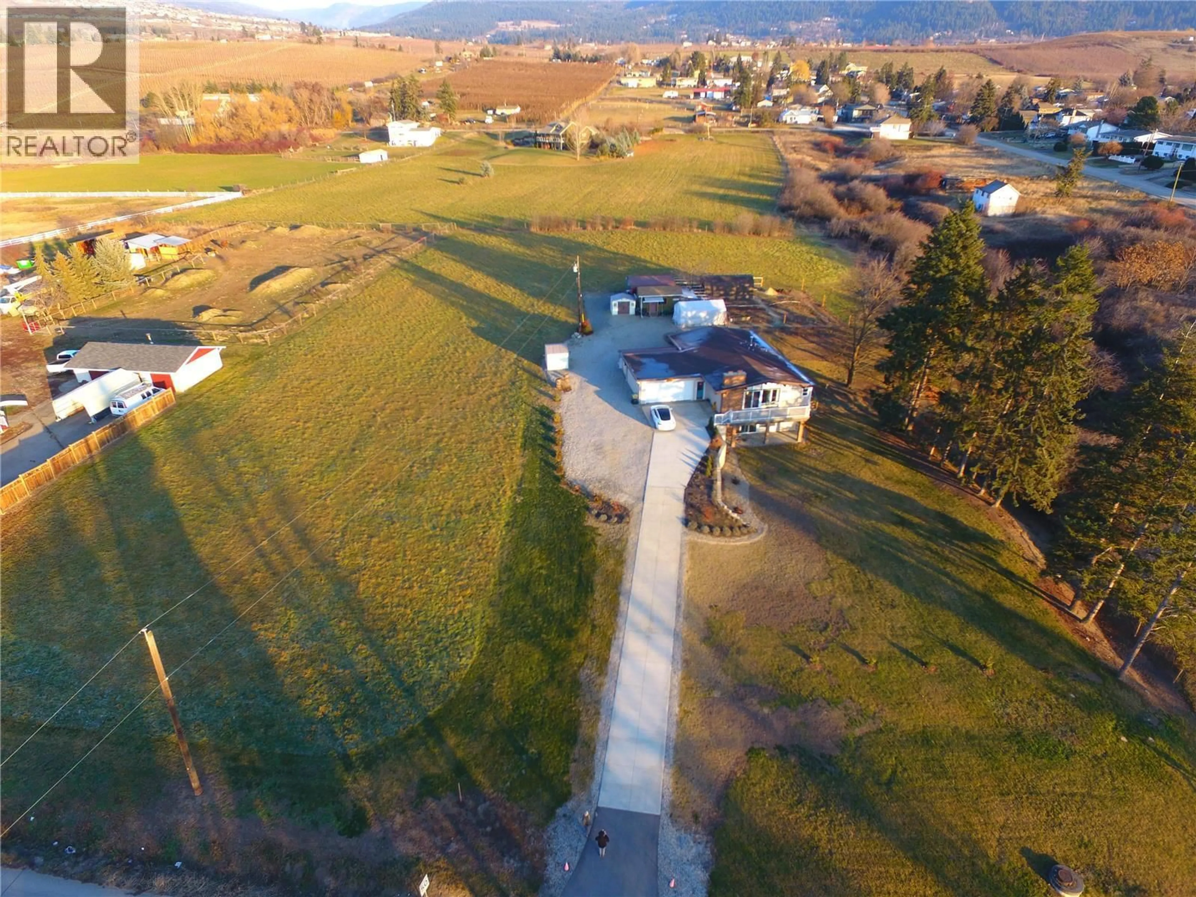 A pic from outside/outdoor area/front of a property/back of a property/a pic from drone, mountain view for 5973 PLEASANT VALLEY ROAD, Vernon British Columbia V1B3L6