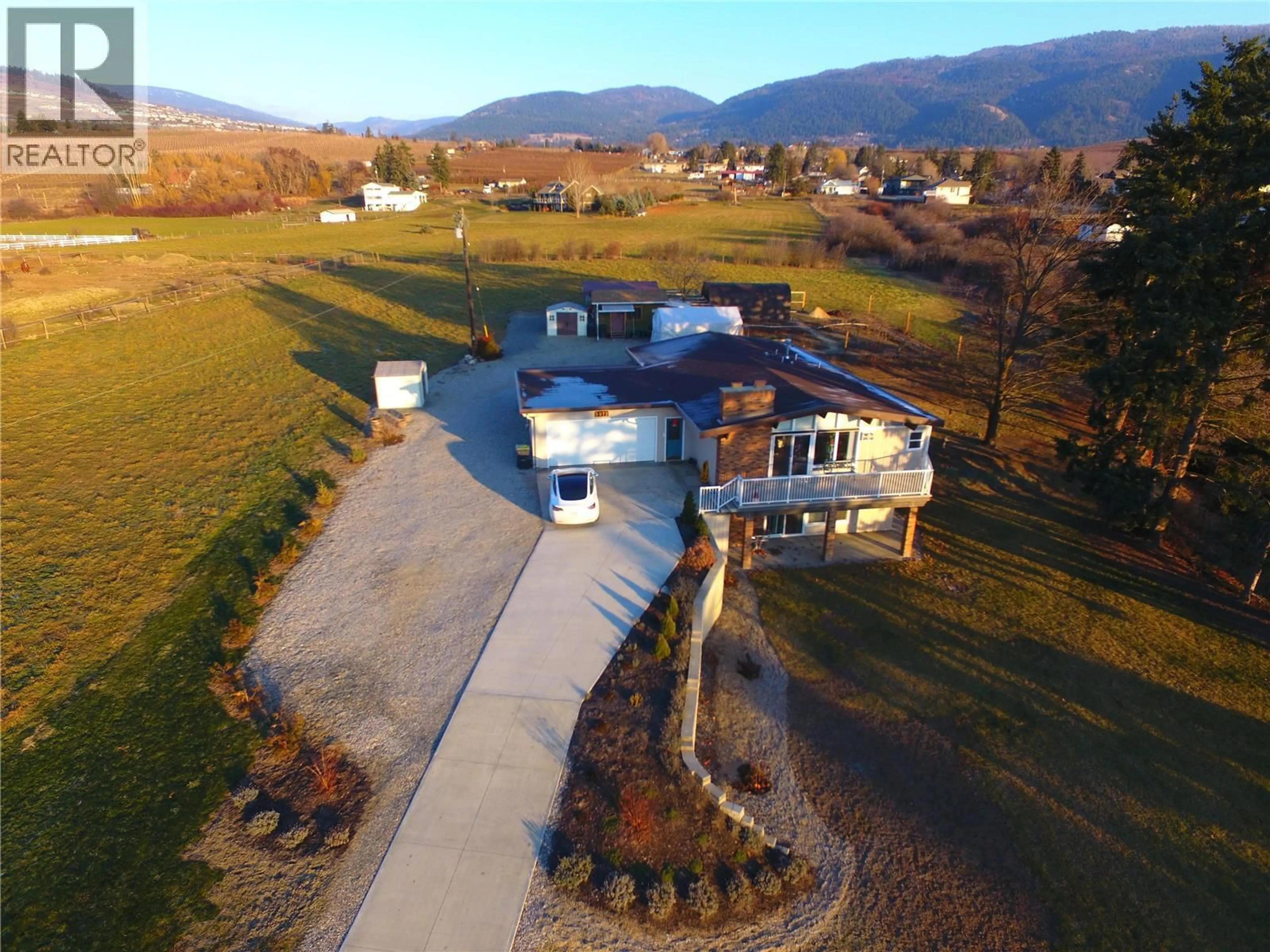 A pic from outside/outdoor area/front of a property/back of a property/a pic from drone, mountain view for 5973 PLEASANT VALLEY ROAD, Vernon British Columbia V1B3L6
