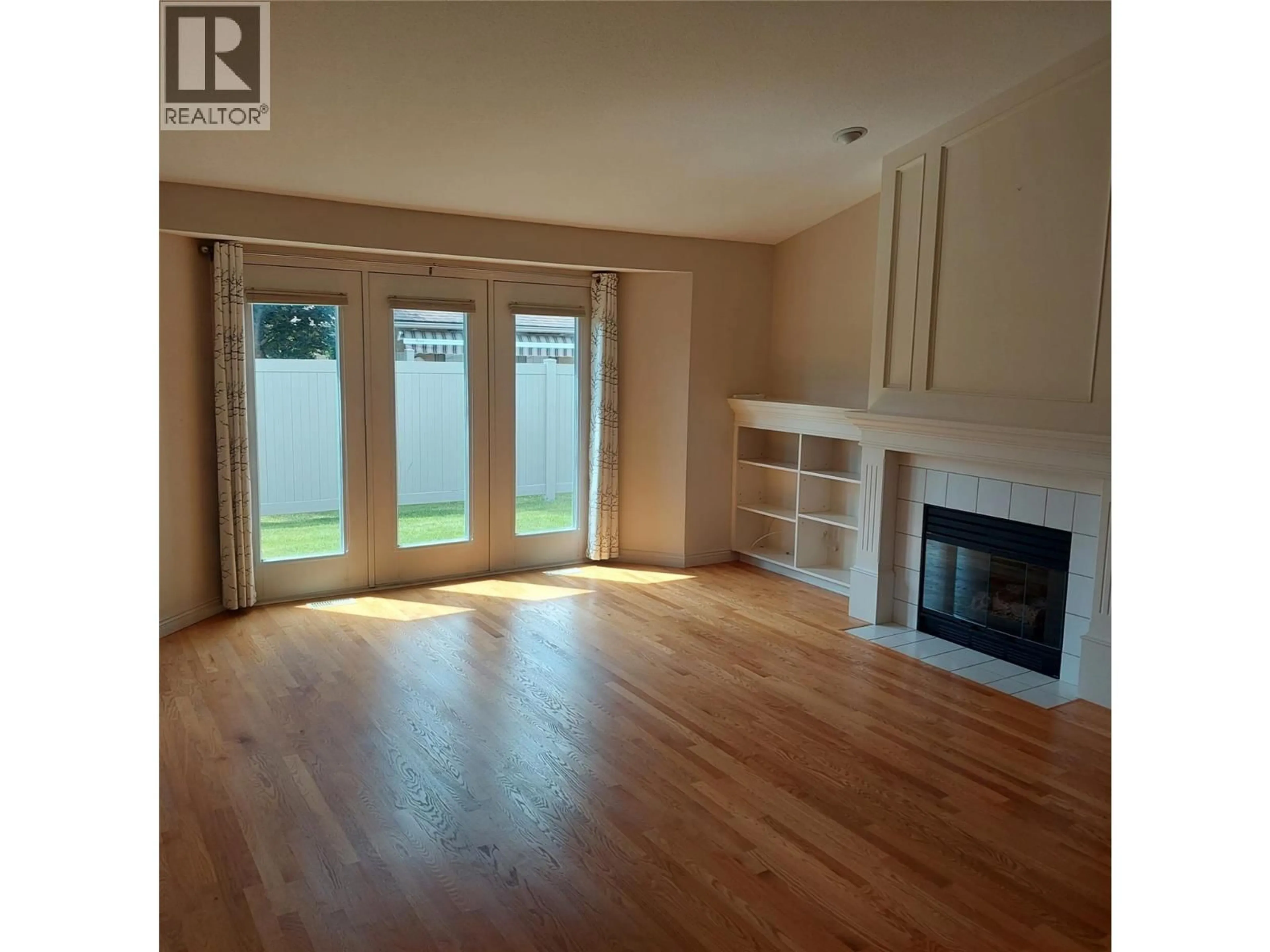 Living room with furniture, wood/laminate floor for 69 - 950 LANFRANCO ROAD, Kelowna British Columbia V1W3X4