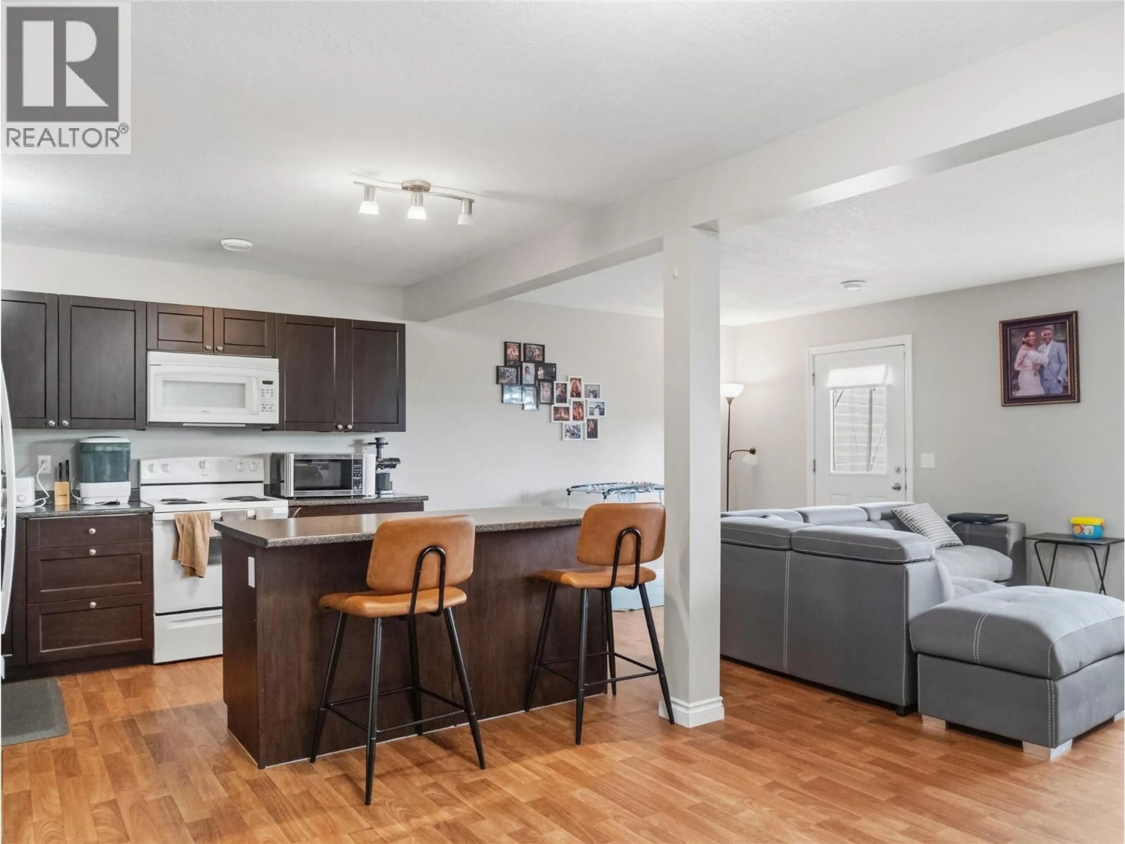 Open concept kitchen, wood/laminate floor for 8206 18 STREET, Dawson Creek British Columbia V1G0G4