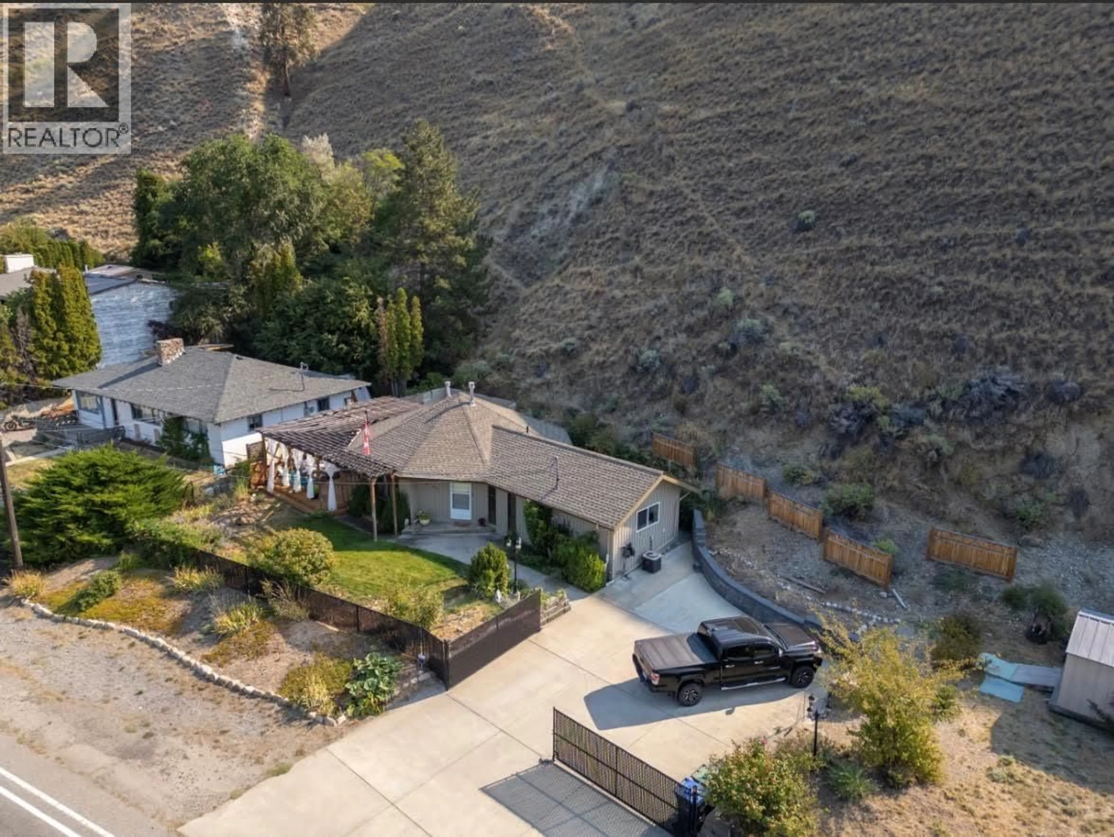 A pic from outside/outdoor area/front of a property/back of a property/a pic from drone, street for 4744 LAKESIDE ROAD, Penticton British Columbia V2A8W6