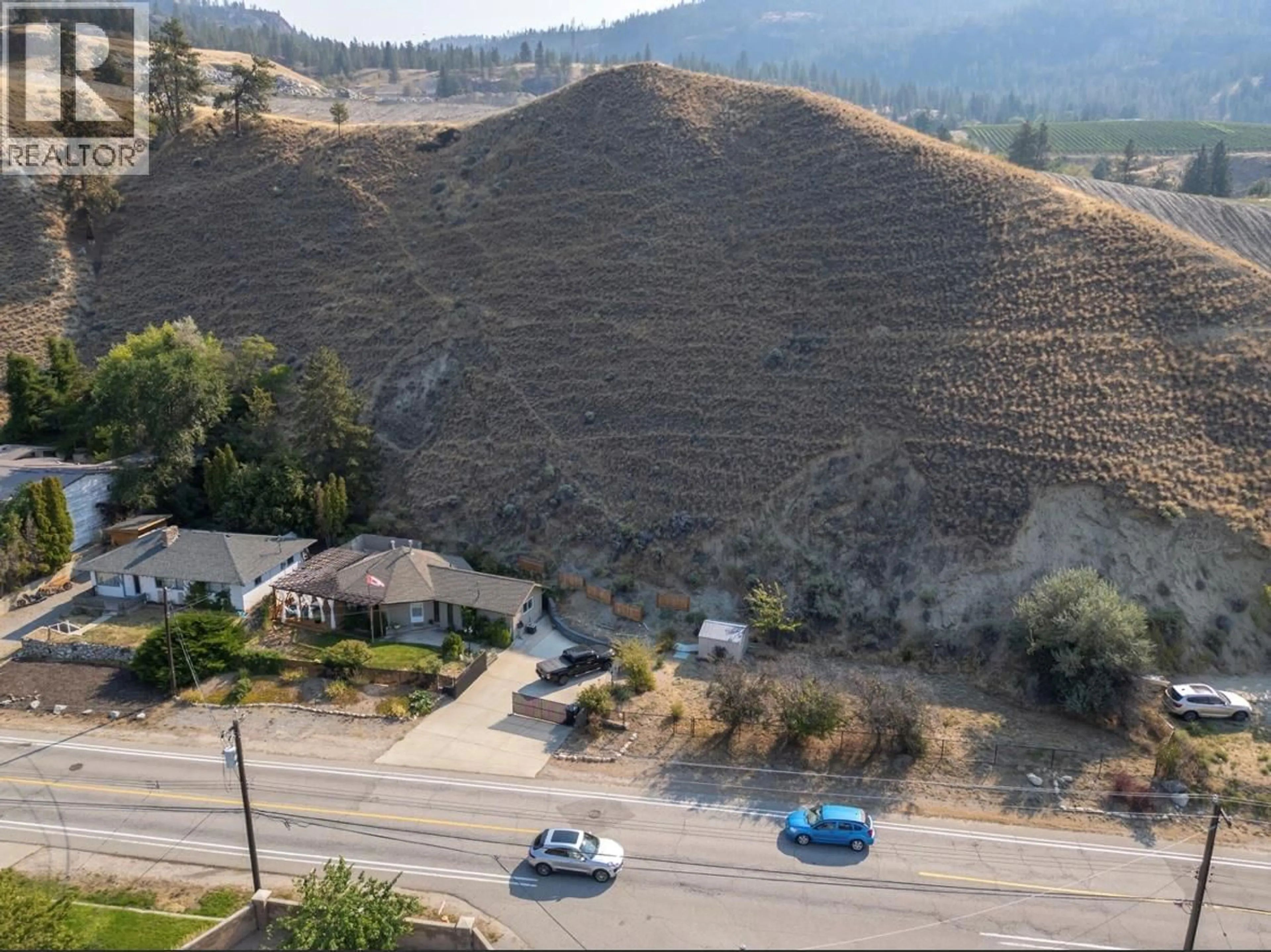 A pic from outside/outdoor area/front of a property/back of a property/a pic from drone, mountain view for 4744 LAKESIDE ROAD, Penticton British Columbia V2A8W6