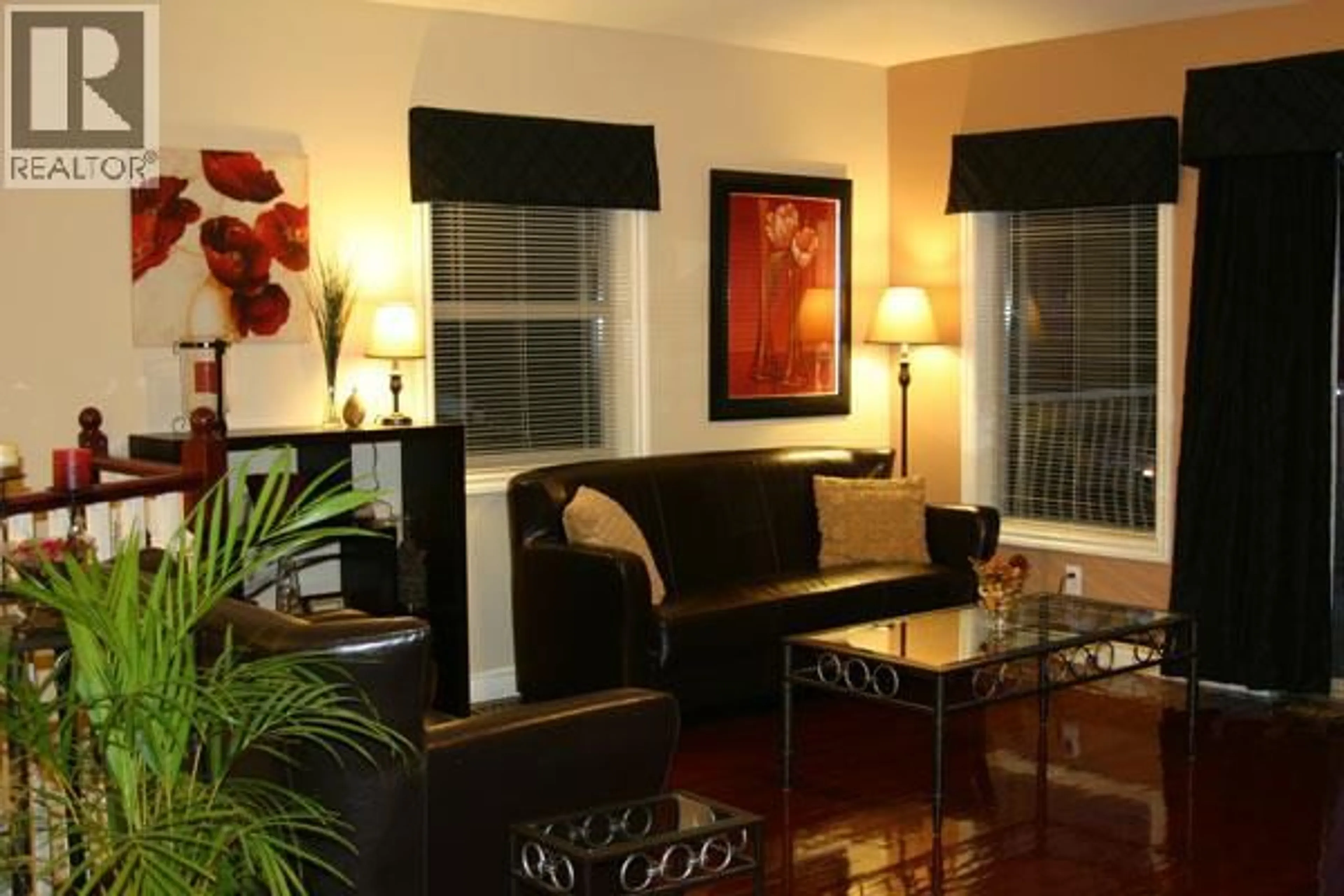 Living room with furniture, wood/laminate floor for 3525 LAKESHORE ROAD, Kelowna British Columbia V1W3K1