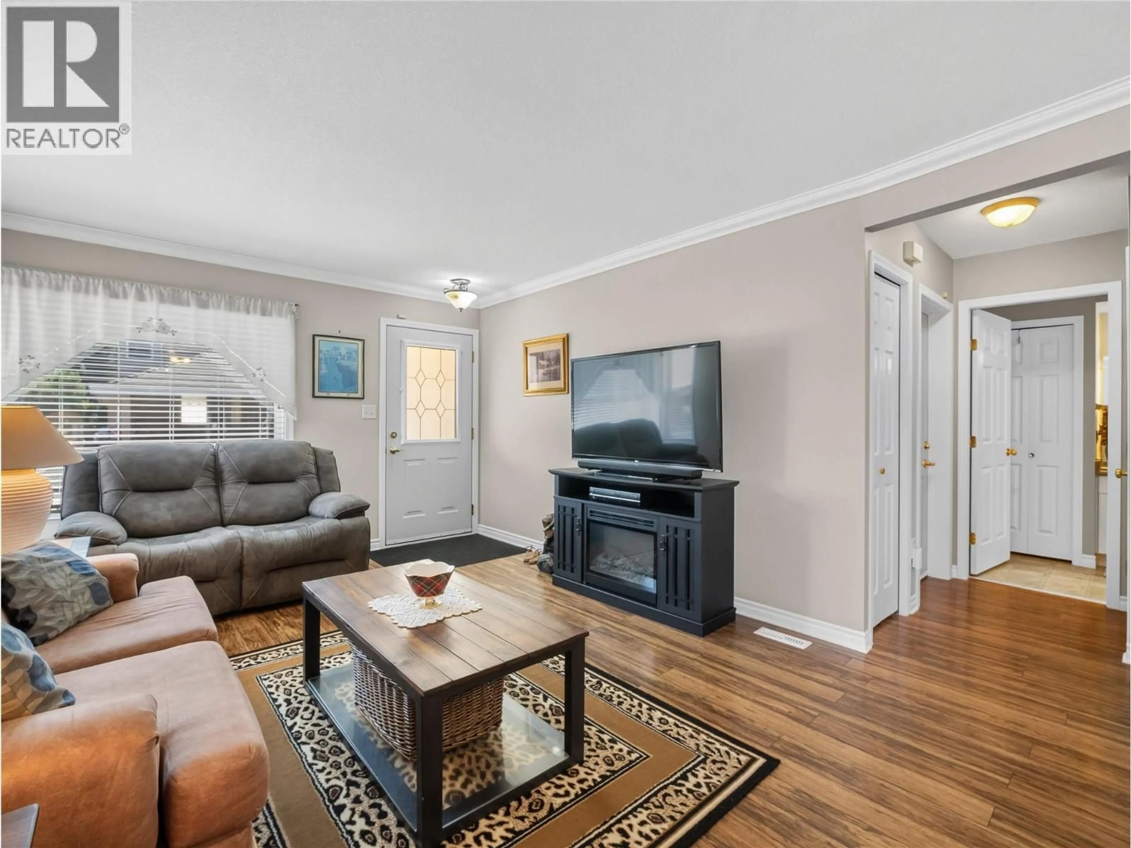 Living room with furniture, wood/laminate floor for 14 - 51 8 AVENUE SOUTHWEST, Salmon Arm British Columbia V1E3L9