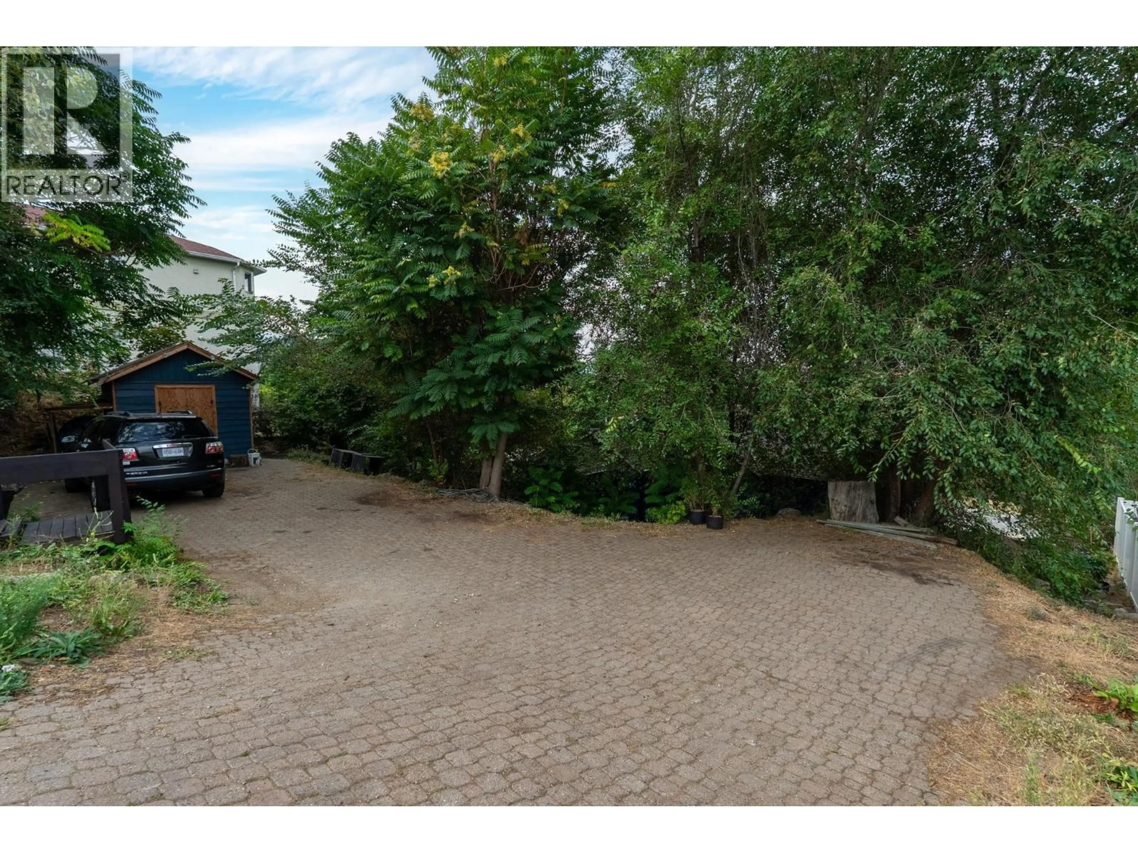 A pic from outside/outdoor area/front of a property/back of a property/a pic from drone, street for 1350 BENTIEN ROAD, Kelowna British Columbia V1X7K3