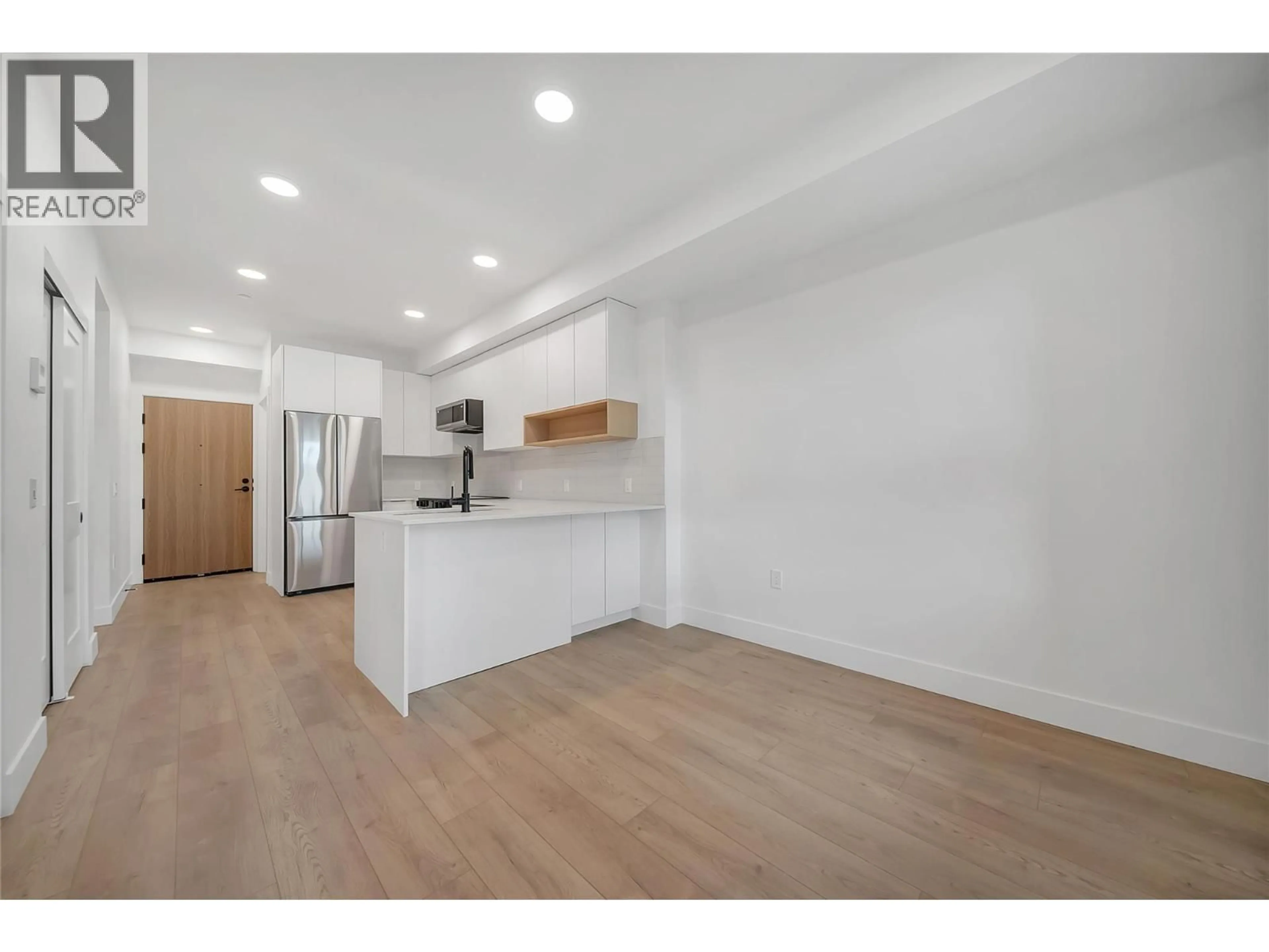 Open concept kitchen, wood/laminate floor for 502 - 620 CORONATION AVENUE, Kelowna British Columbia V1Y7A5