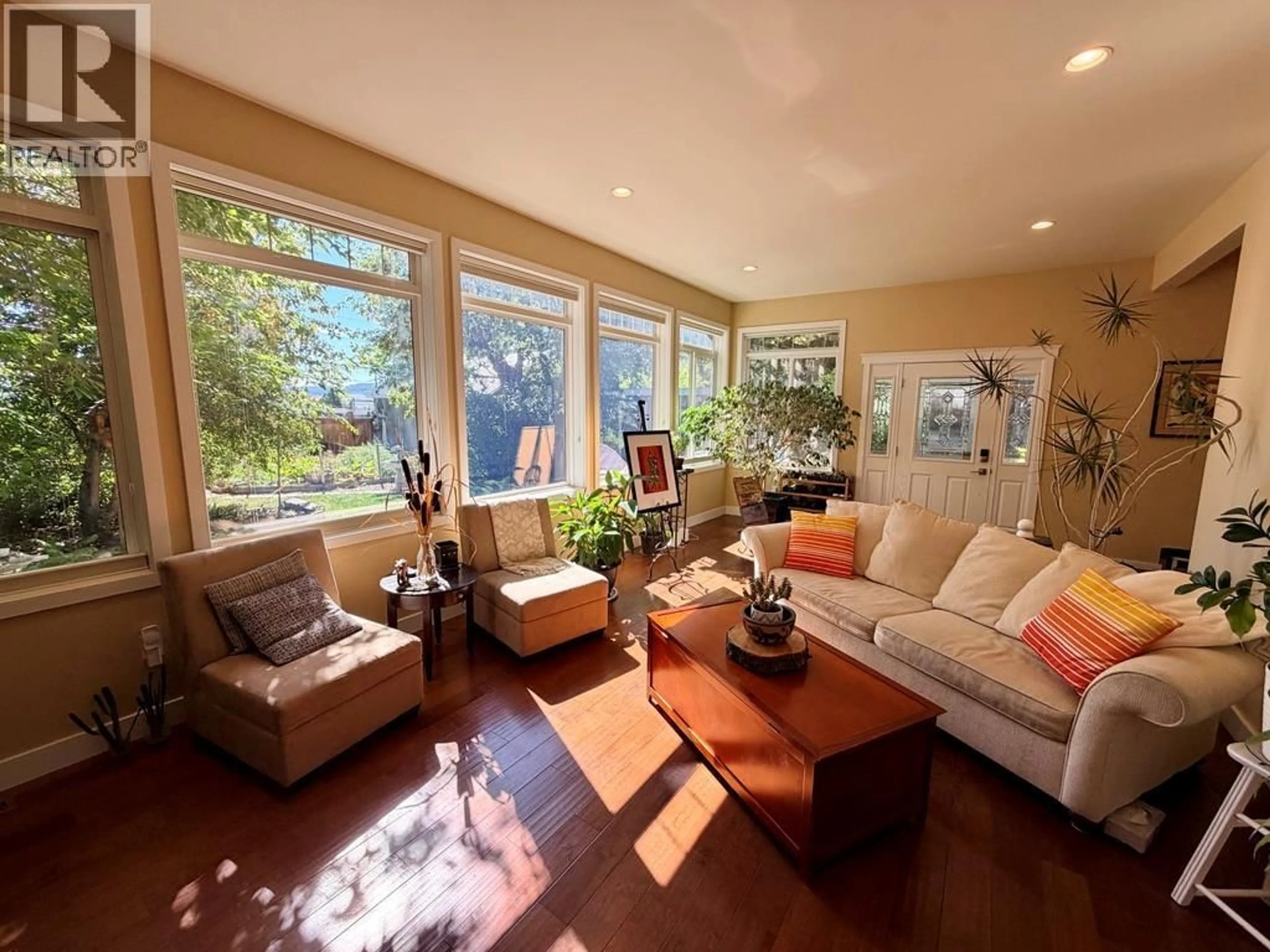 Living room with furniture, wood/laminate floor for 1045 93 AVENUE, Dawson Creek British Columbia V1G1E3