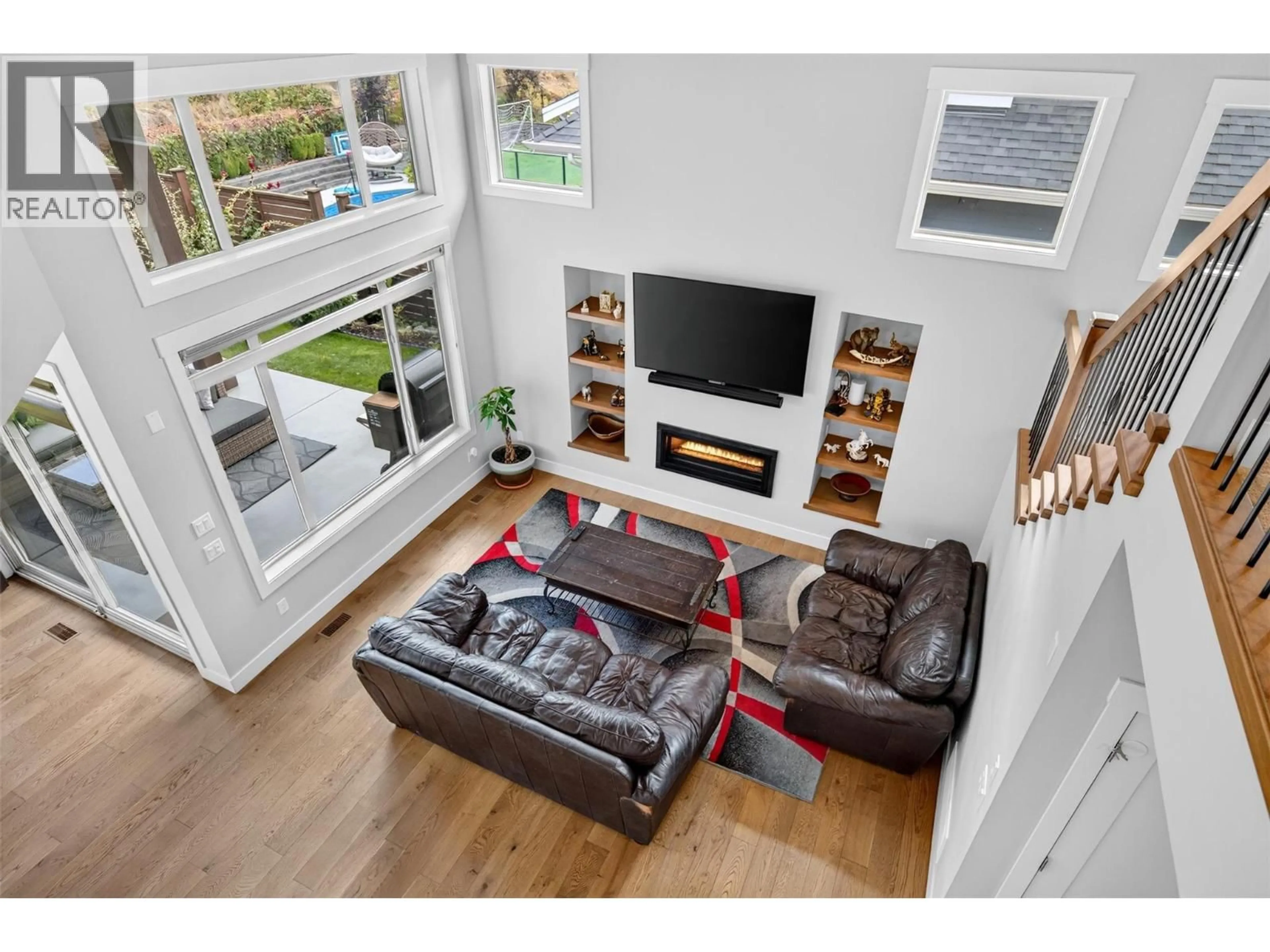 Living room with furniture, wood/laminate floor for 195 LOST CREEK COURT, Kelowna British Columbia V1V3B7