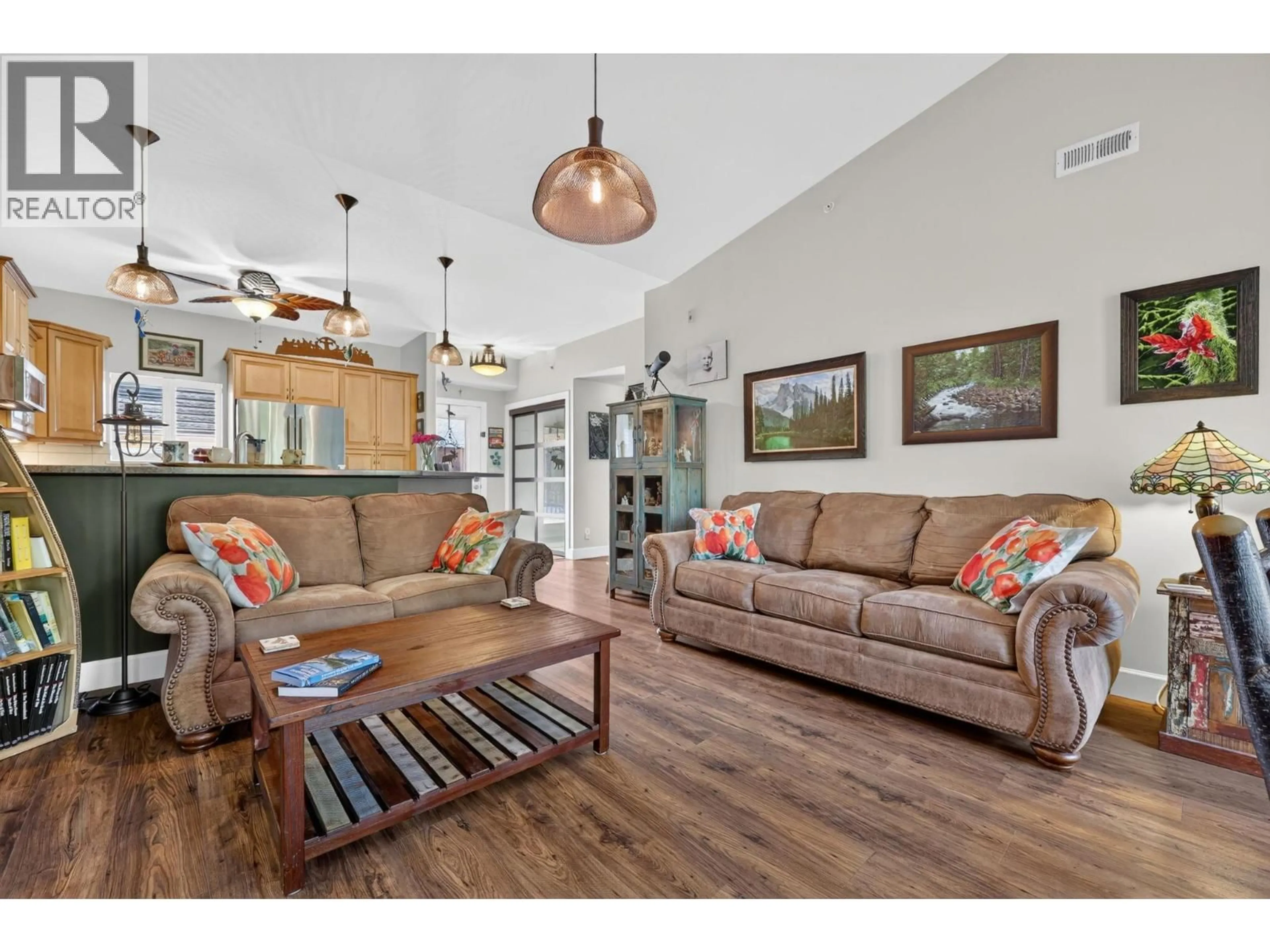 Living room with furniture, wood/laminate floor for 308 - 3996 BEACH AVENUE, Peachland British Columbia V0H1X5