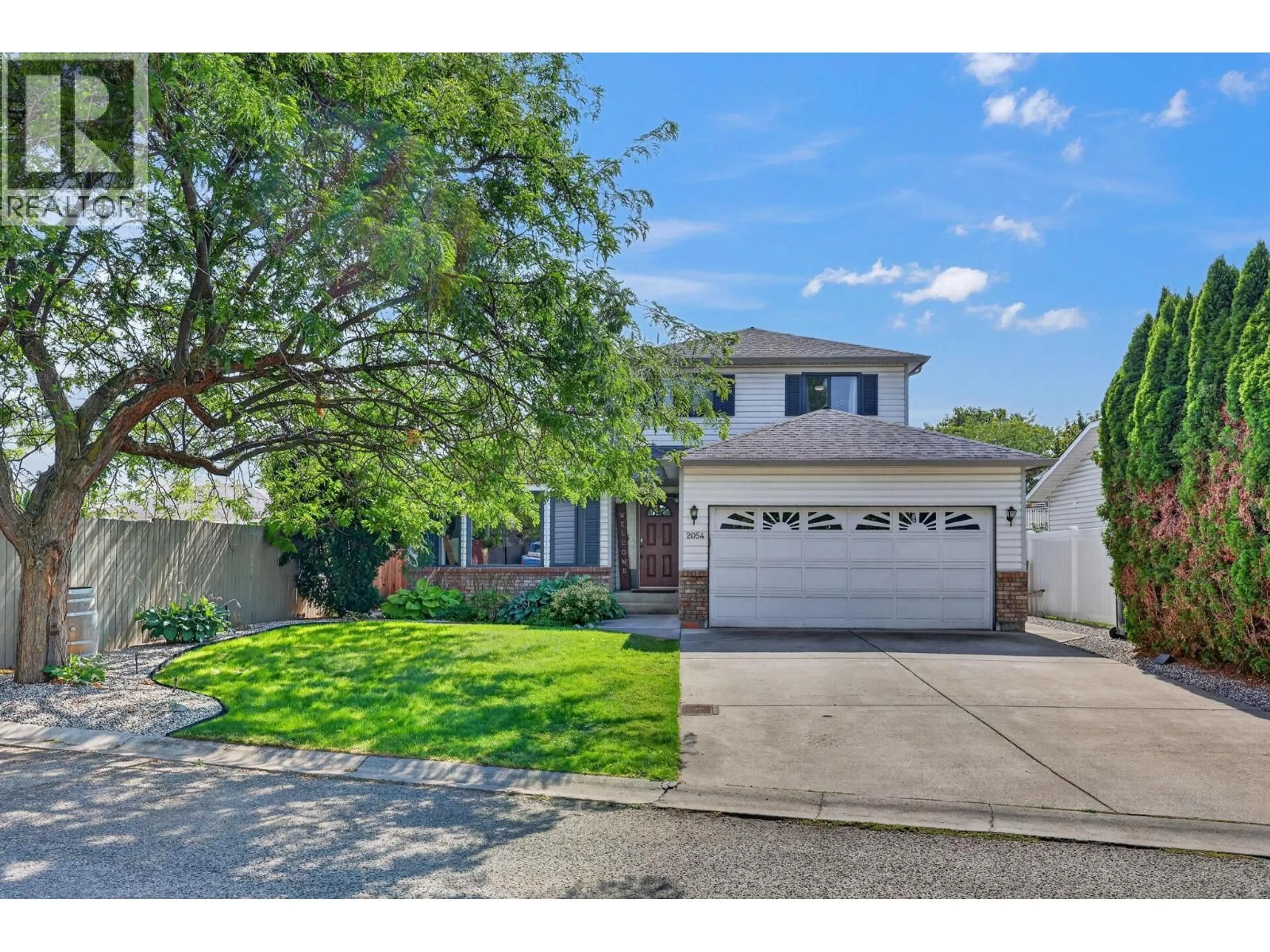 Home with vinyl exterior material, street for 2054 ASTER ROAD, Kelowna British Columbia V1V1P4