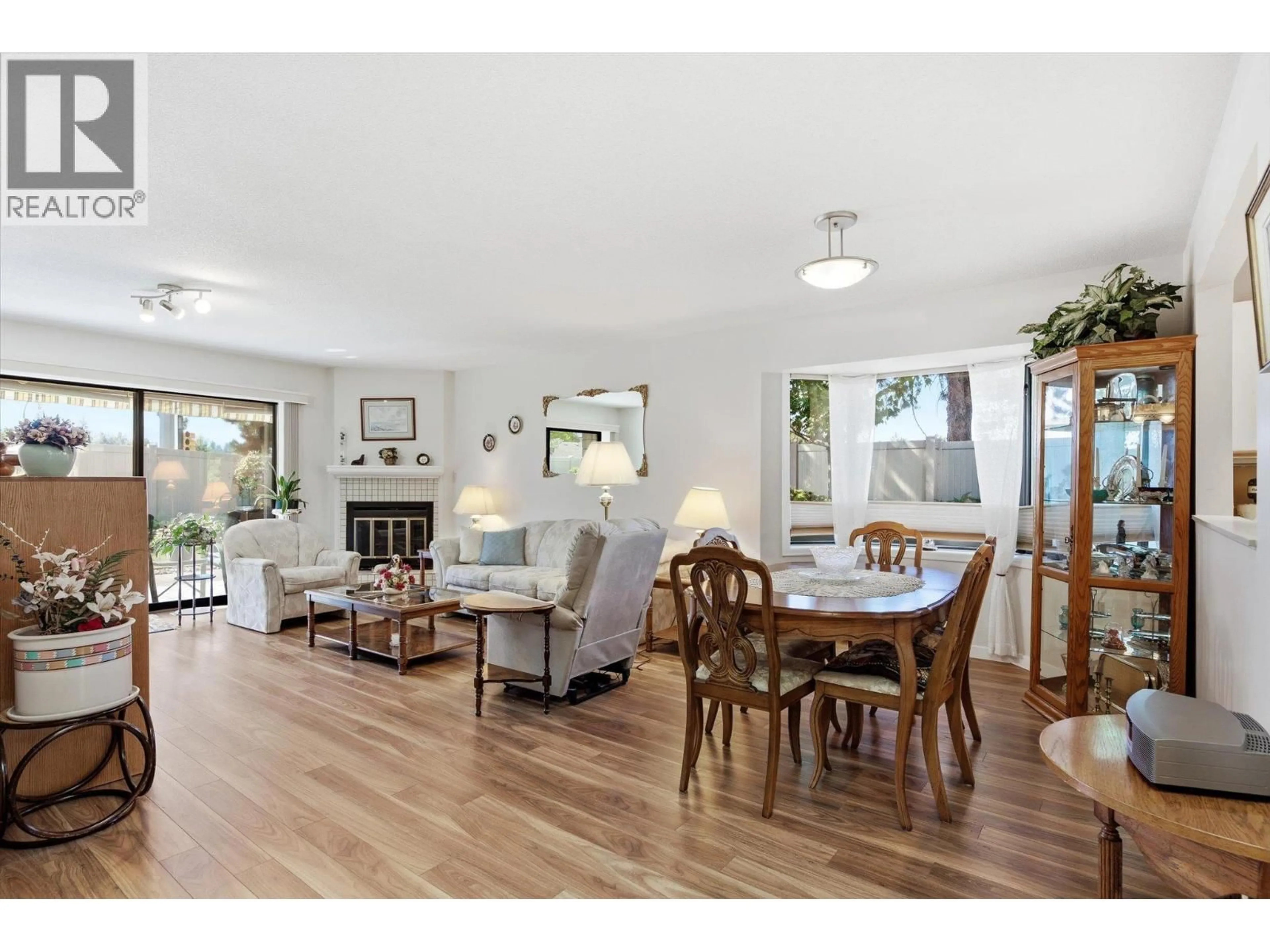 Living room with furniture, wood/laminate floor for 201 - 1765 LECKIE ROAD, Kelowna British Columbia V1X6X5