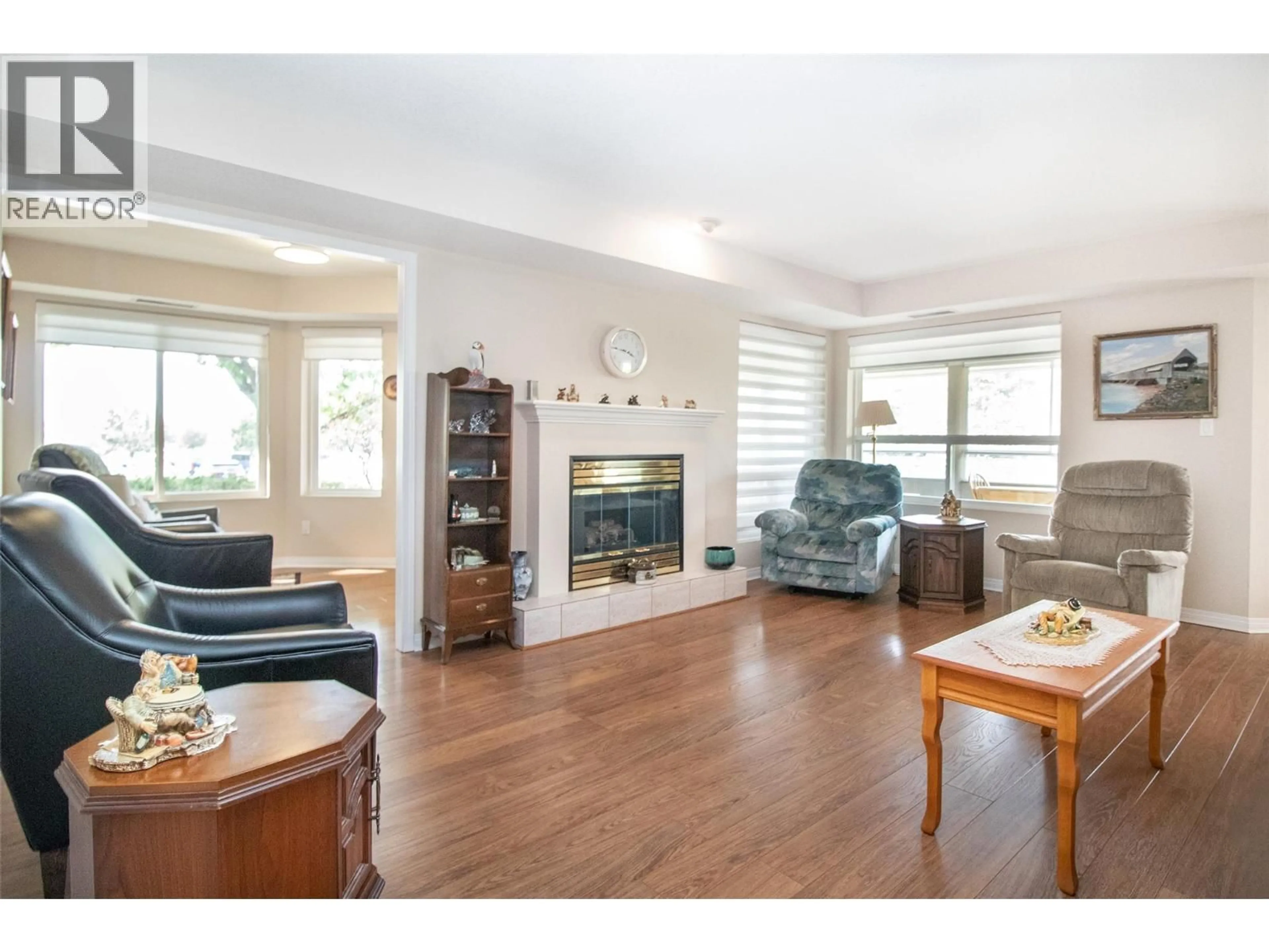 Living room with furniture, wood/laminate floor for 122 - 1965 DURNIN ROAD, Kelowna British Columbia V1X7K6