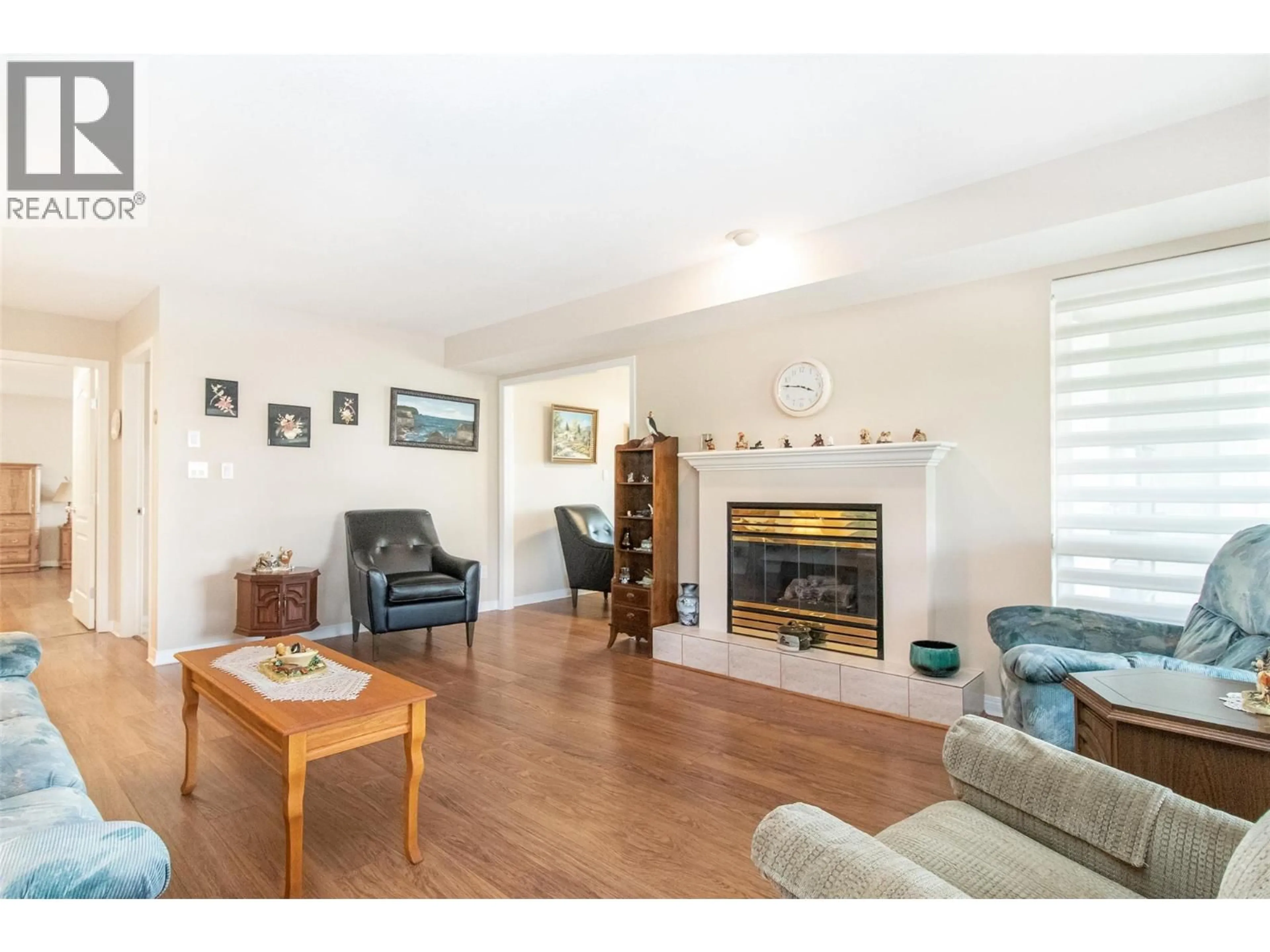Living room with furniture, wood/laminate floor for 122 - 1965 DURNIN ROAD, Kelowna British Columbia V1X7K6