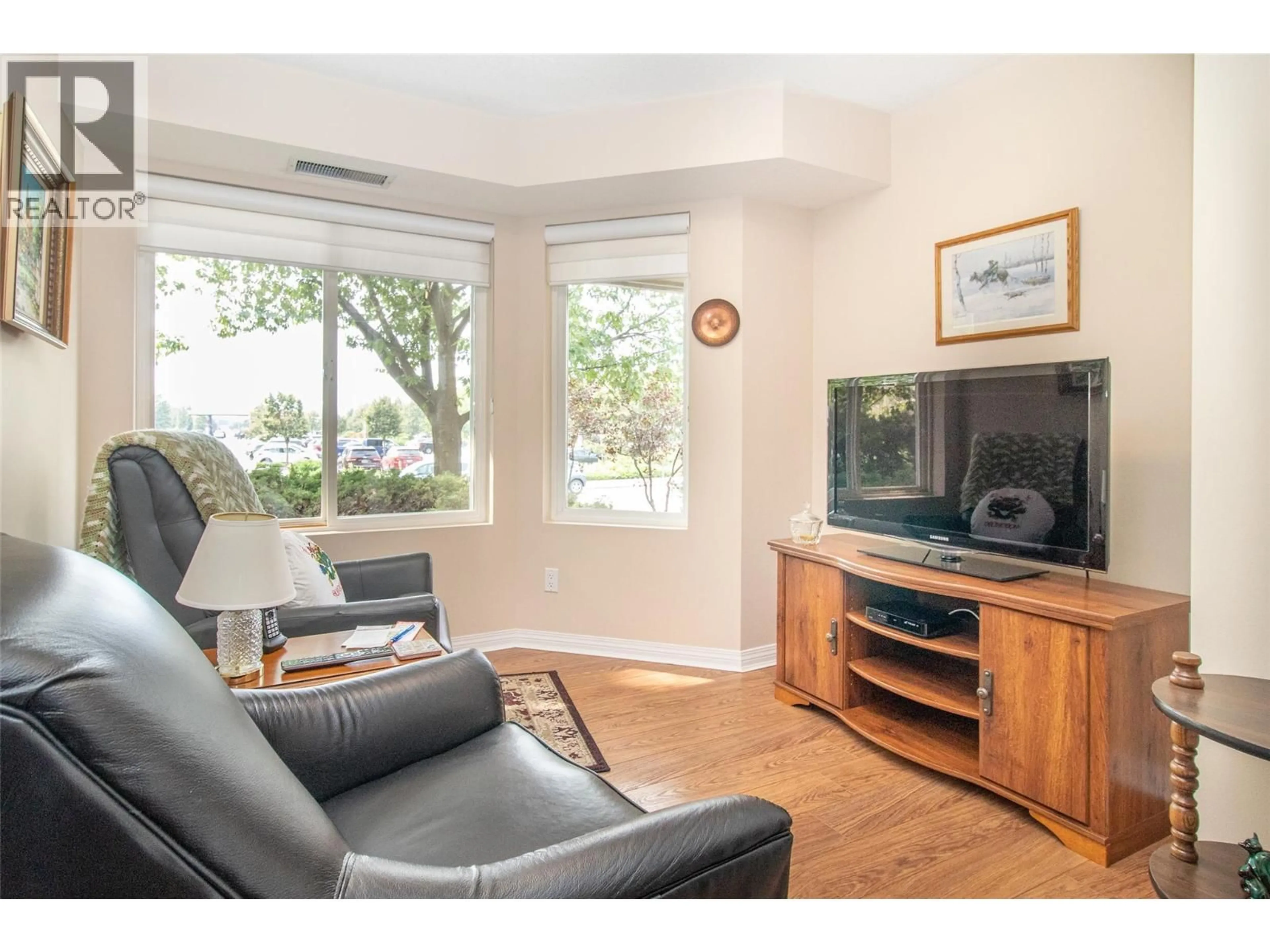 Living room with furniture, wood/laminate floor for 122 - 1965 DURNIN ROAD, Kelowna British Columbia V1X7K6