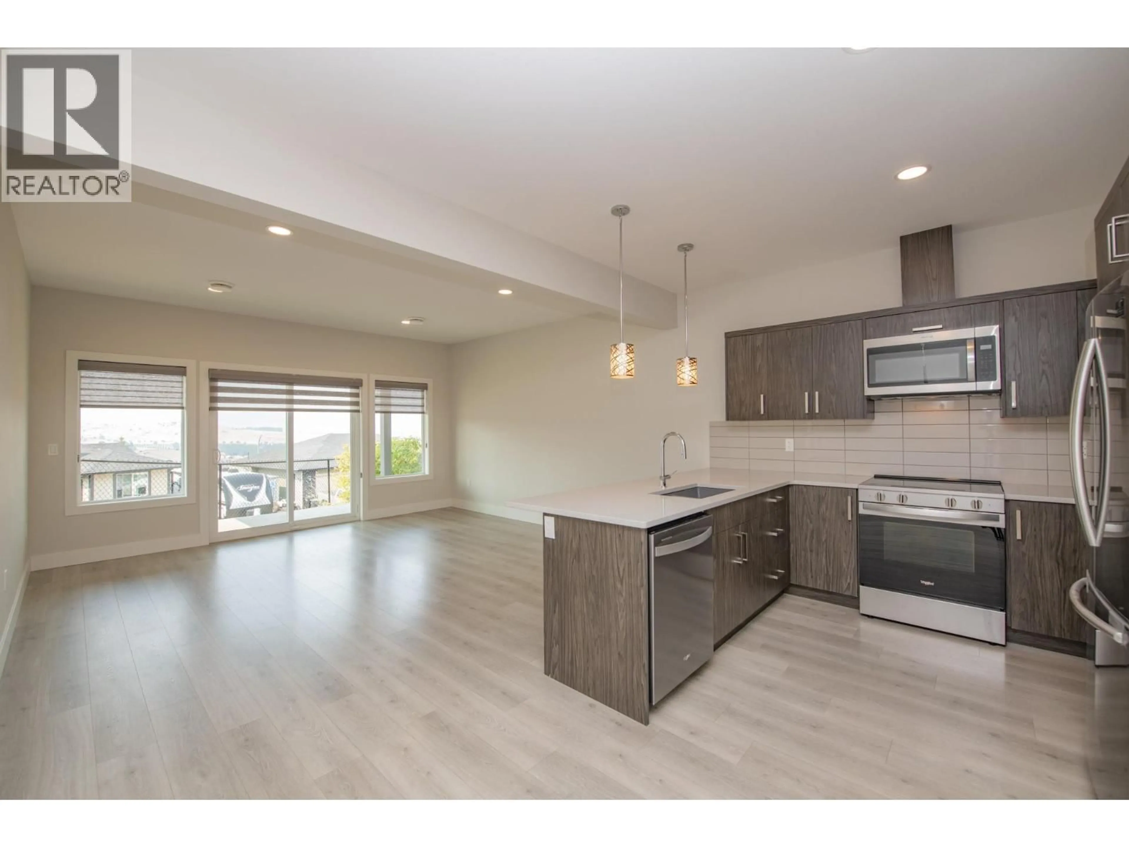 Open concept kitchen, wood/laminate floor for 97 - 933 MT ROBSON PLACE, Vernon British Columbia V1B4G4