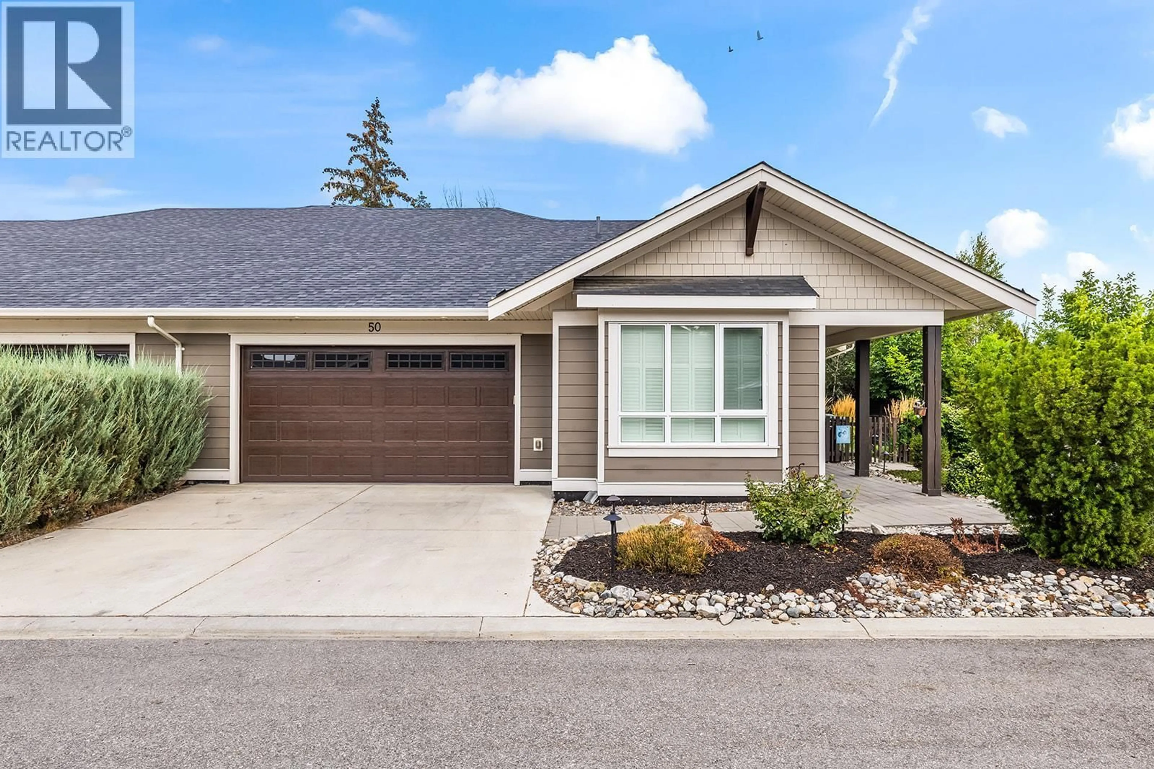 Home with vinyl exterior material, street for 50 - 1960 KLO ROAD, Kelowna British Columbia V1W5L2