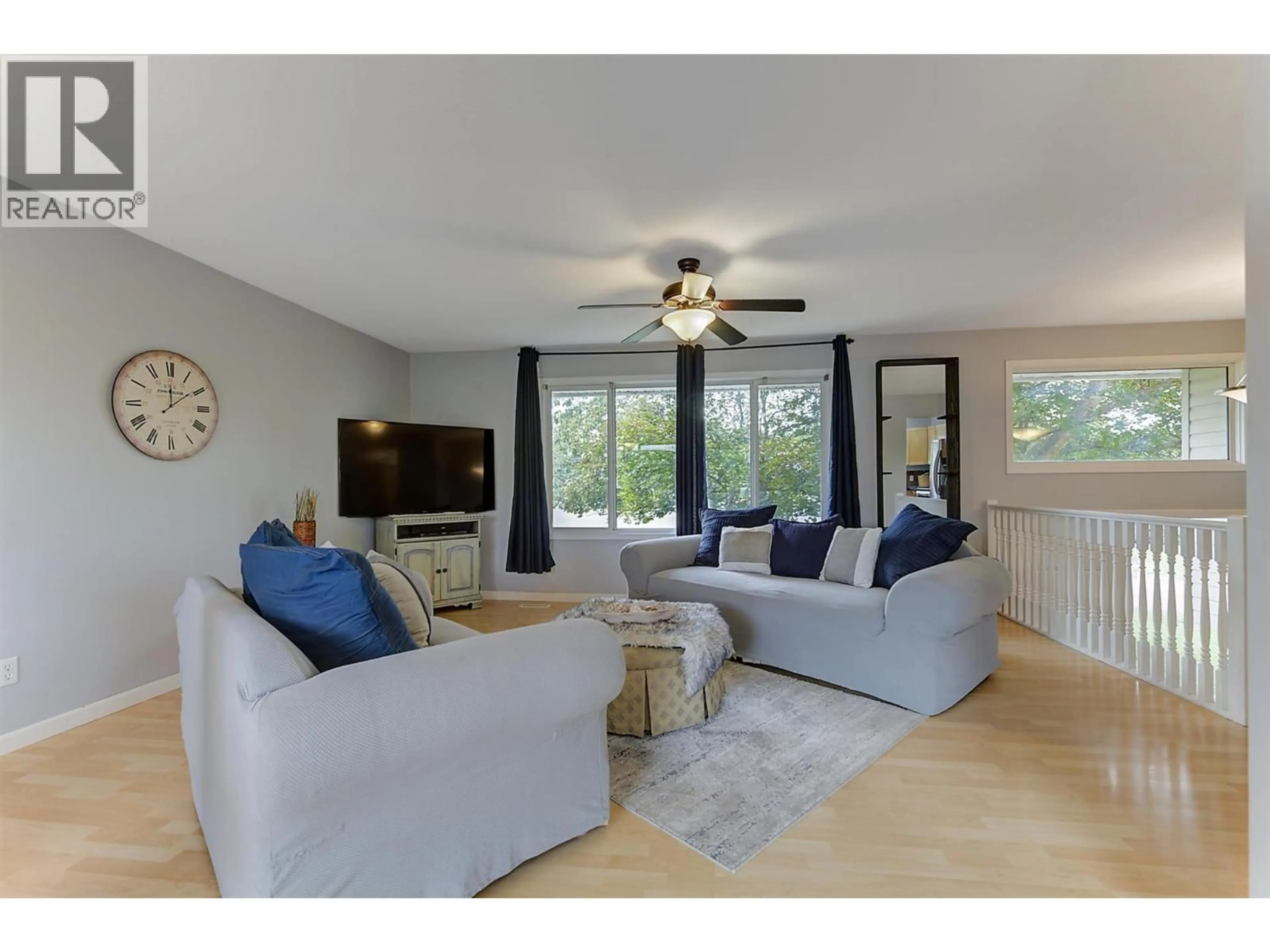 Living room with furniture, wood/laminate floor for 160 LEO ROAD, Kelowna British Columbia V1X1E8