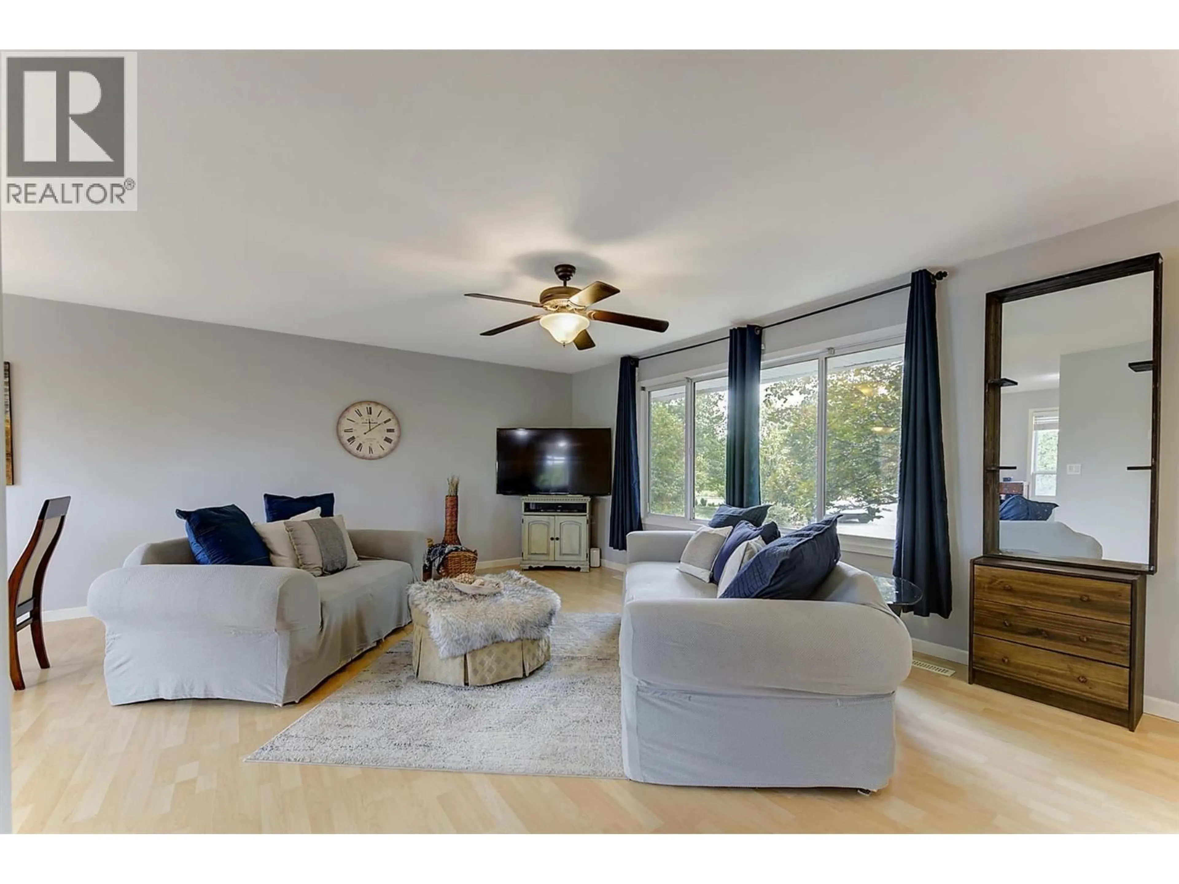 Living room with furniture, wood/laminate floor for 160 LEO ROAD, Kelowna British Columbia V1X1E8